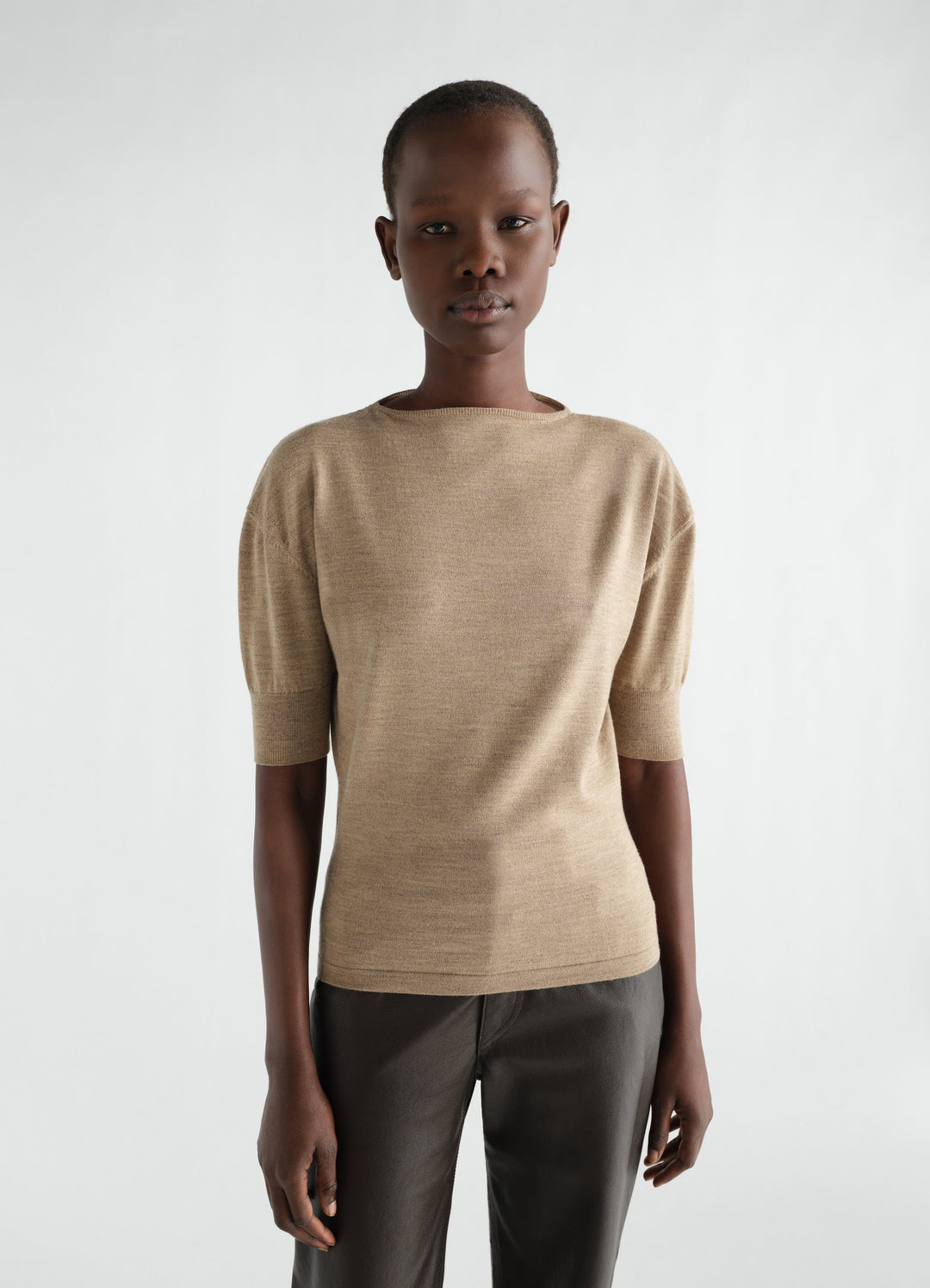 Short-sleeve beige fine merino wool sweater by LEMAIRE worn by a model front view
