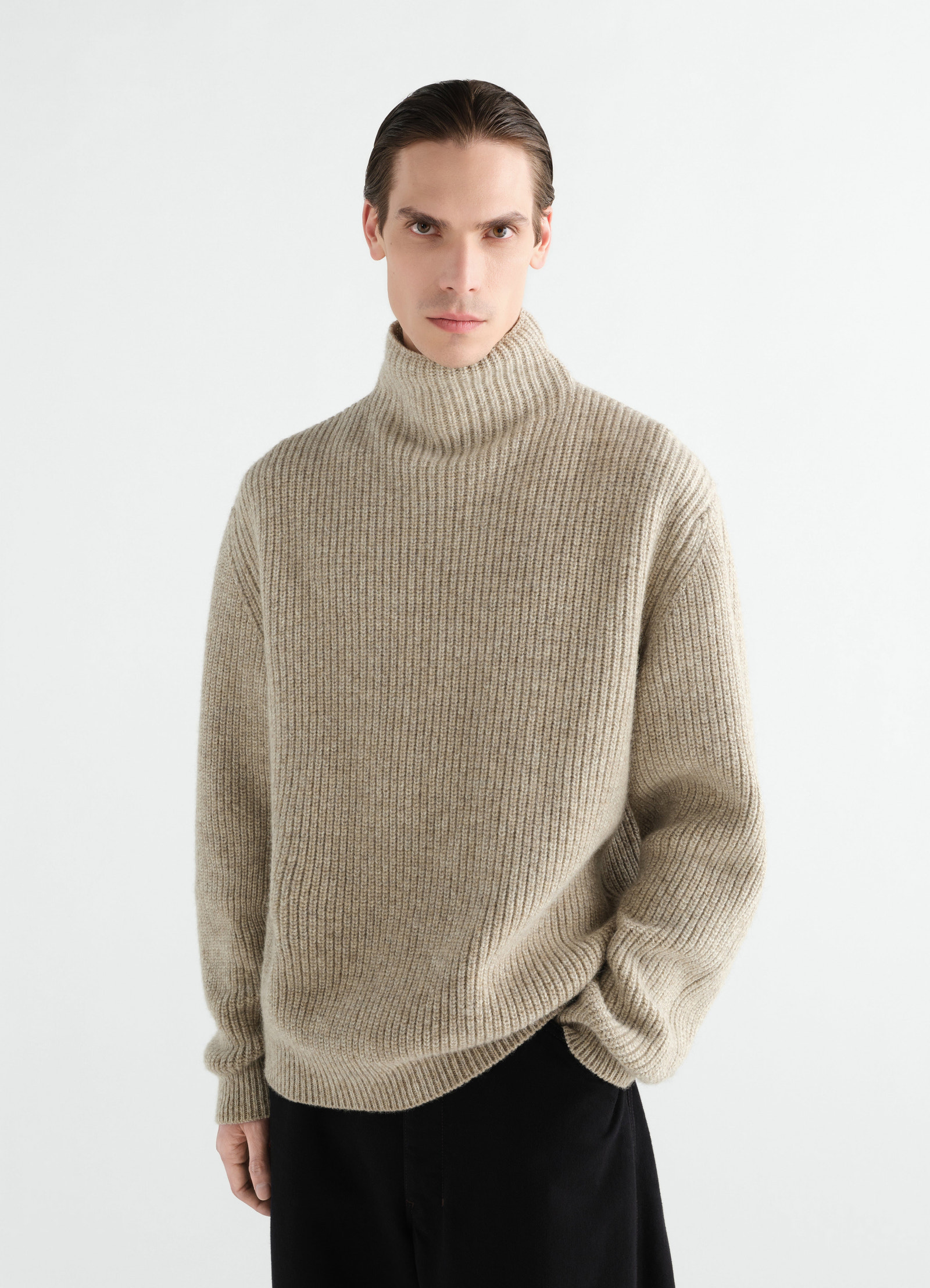 High neck beige yak alpaca sweater by lemaire worn by model in front view with relaxed fit
