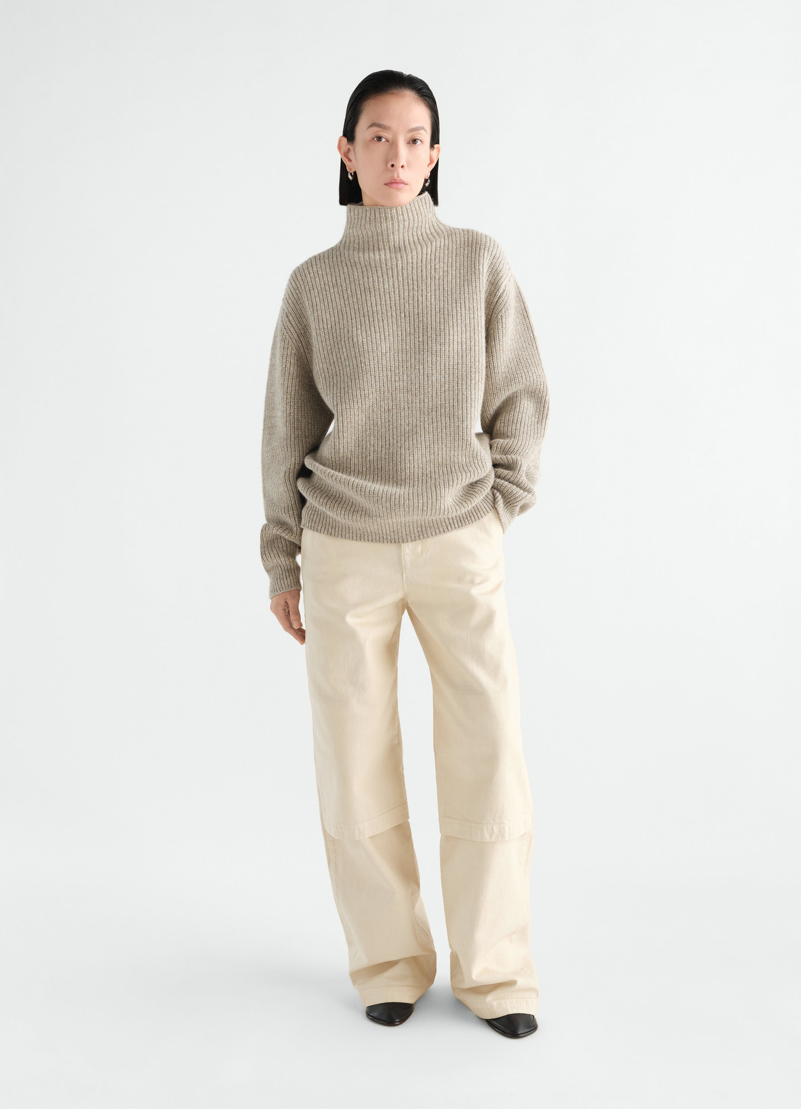 High neck beige yak alpaca sweater lemaire worn by model with cream wide trousers front view