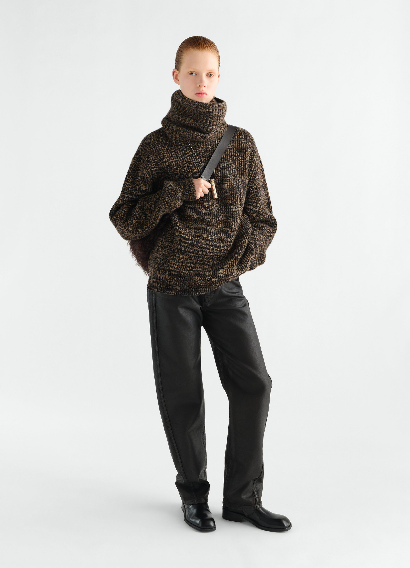 High neck brown yak alpaca sweater lemaire worn by model front with black leather pants and boots