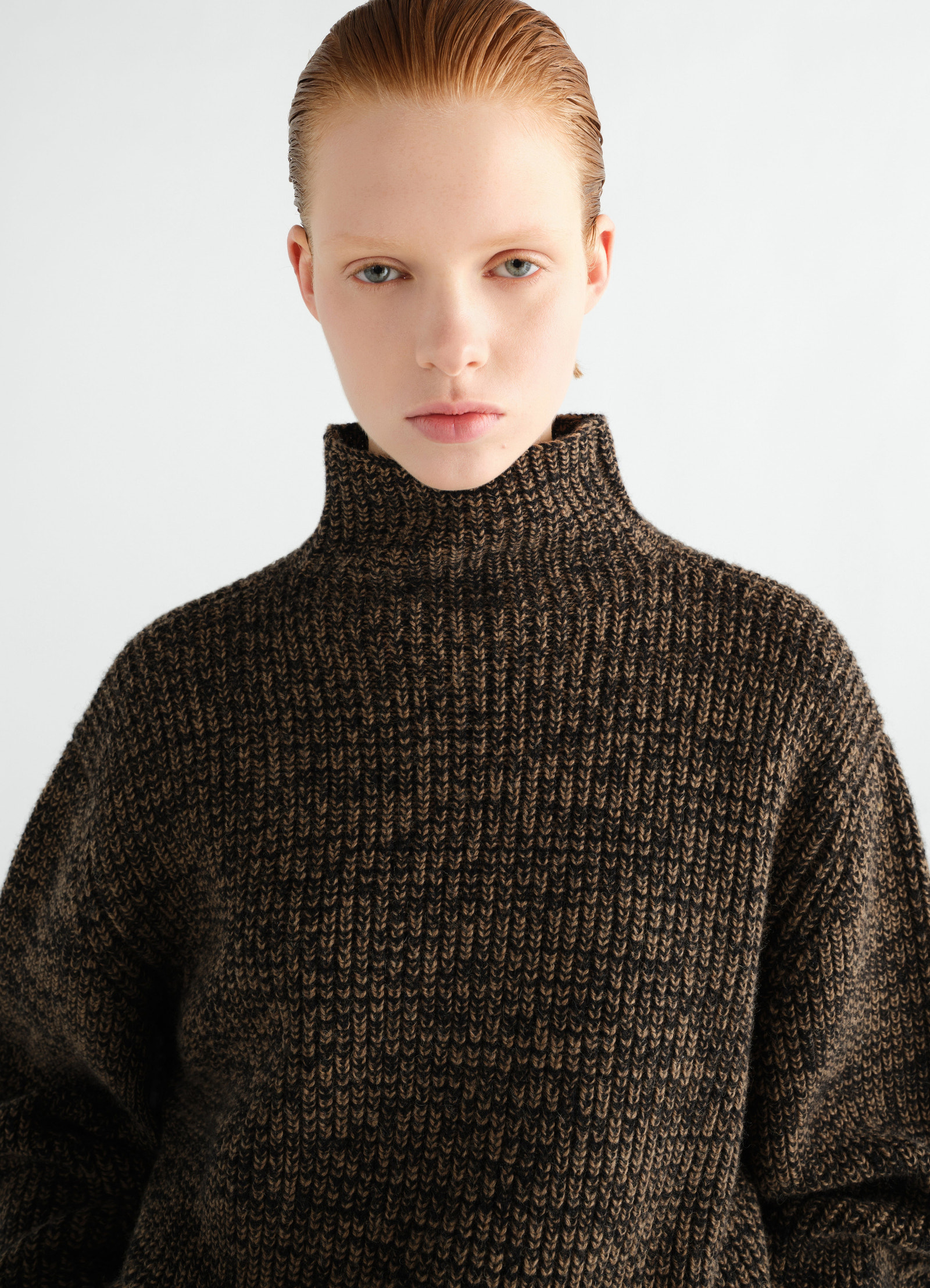 High neck black and brown yak alpaca sweater by lemaire worn by model front close-up