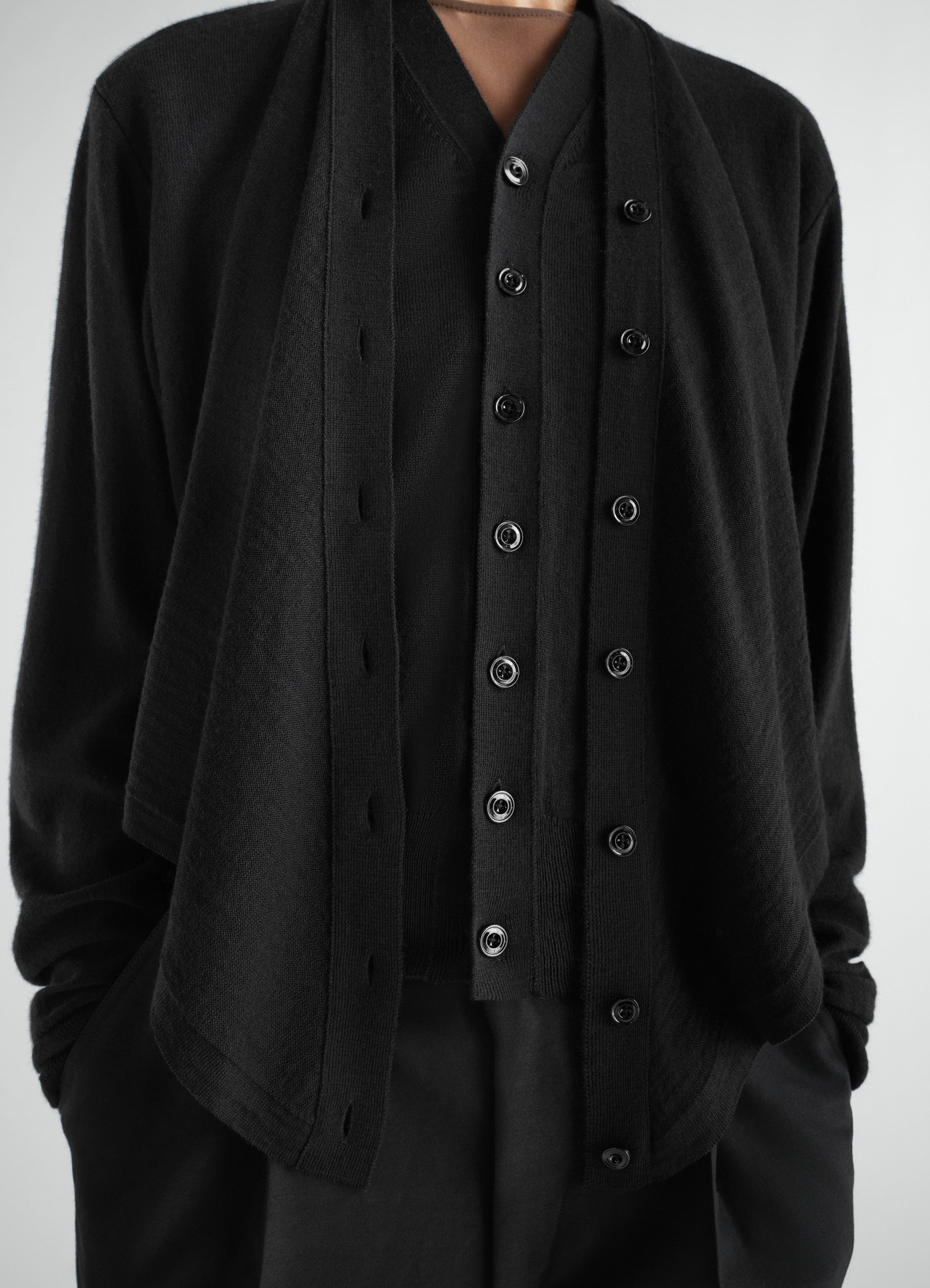 Trompe-l’œil black merino wool blend cardigan with double button front worn by model lemaire