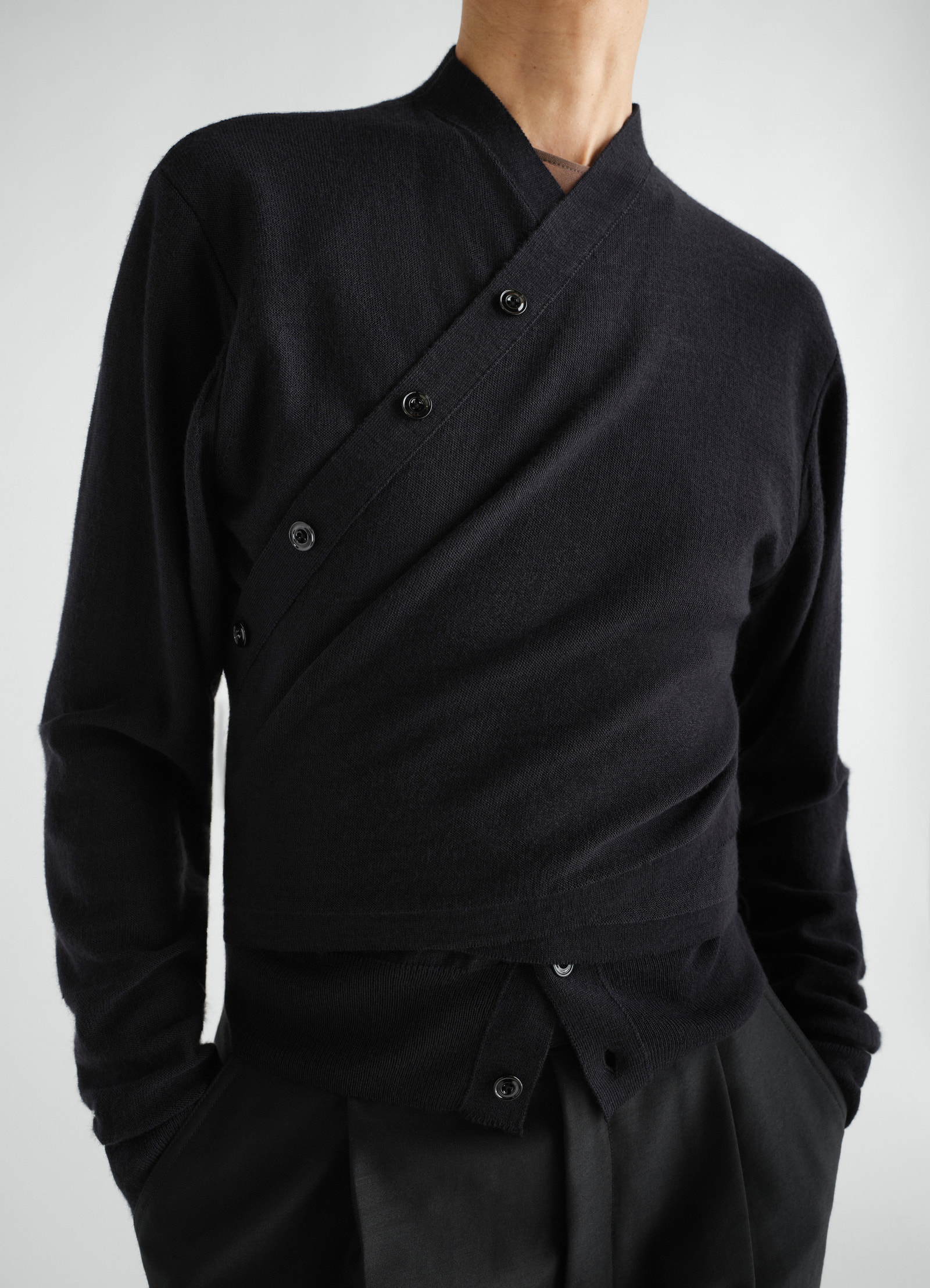 Black merino wool blend trompe-l’œil cardigan with buttons by lemaire worn by model front close-up