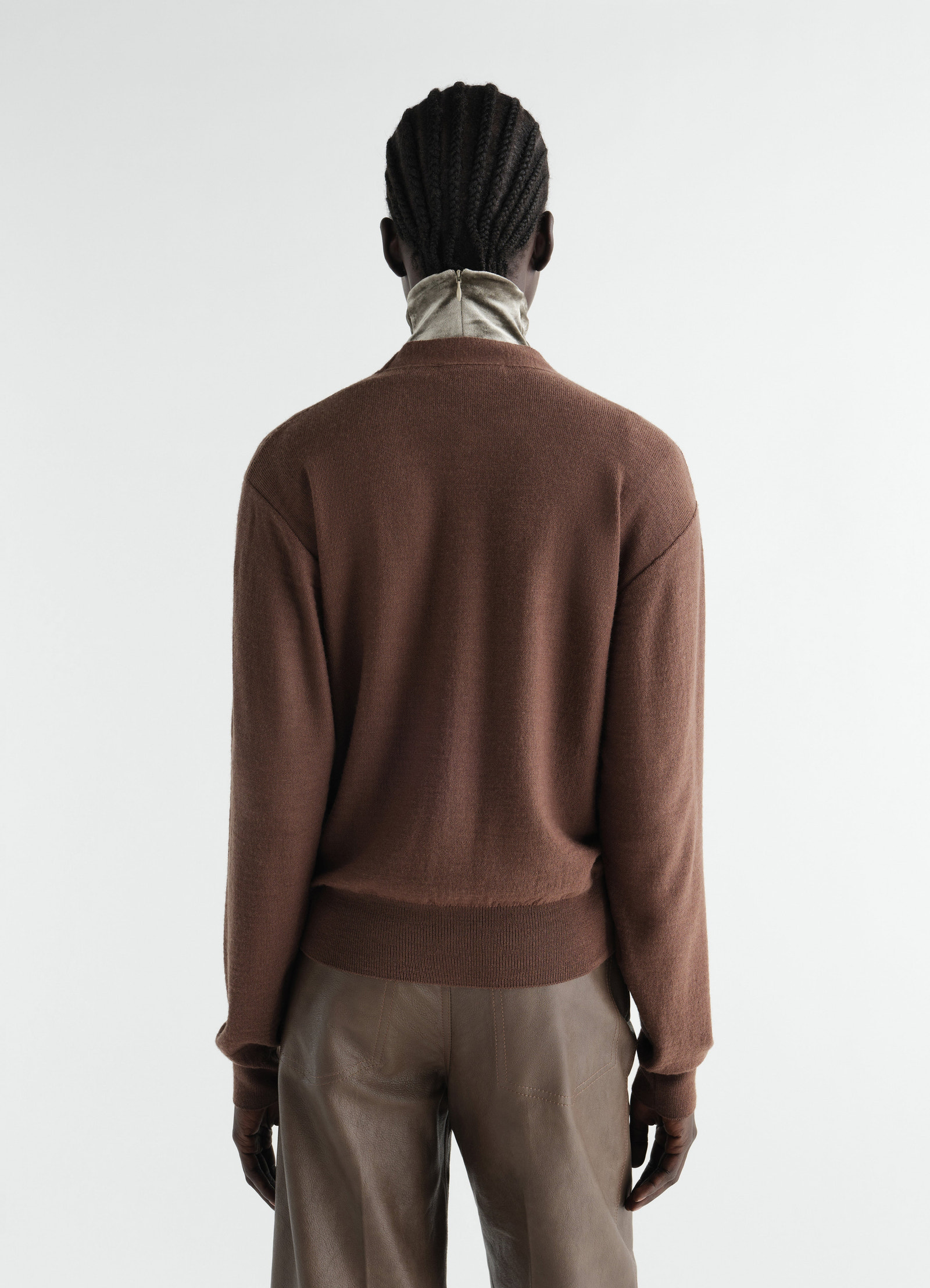 Trompe-l’œil brown merino wool blend cardigan by lemaire worn by model back view with beige collar detail