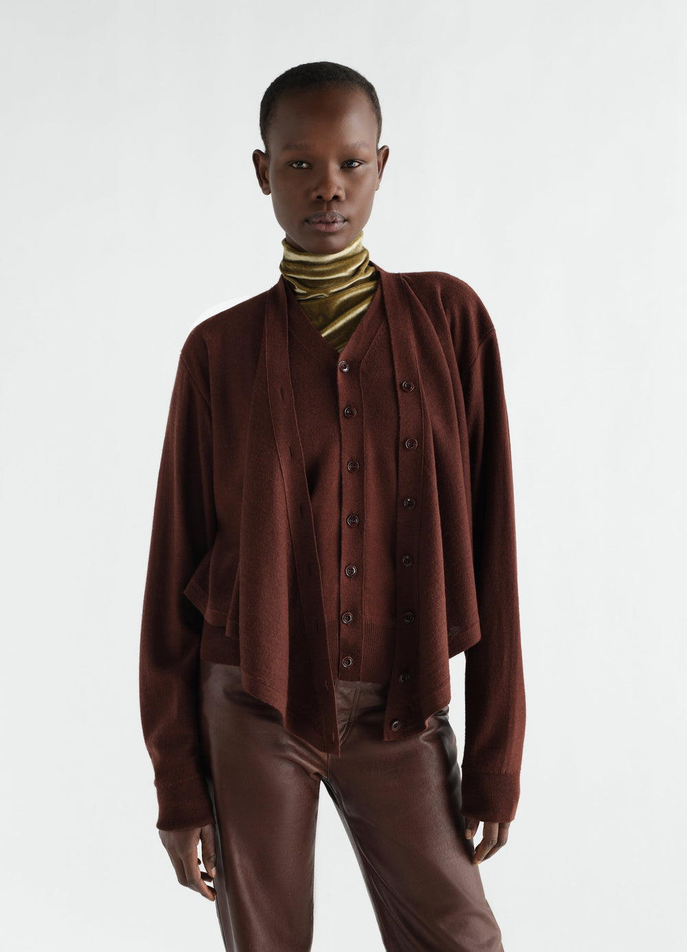 Trompe-L’Œil cardigan in brown merino wool blend worn by model with olive velvet turtleneck and leather pants LEMAIRE