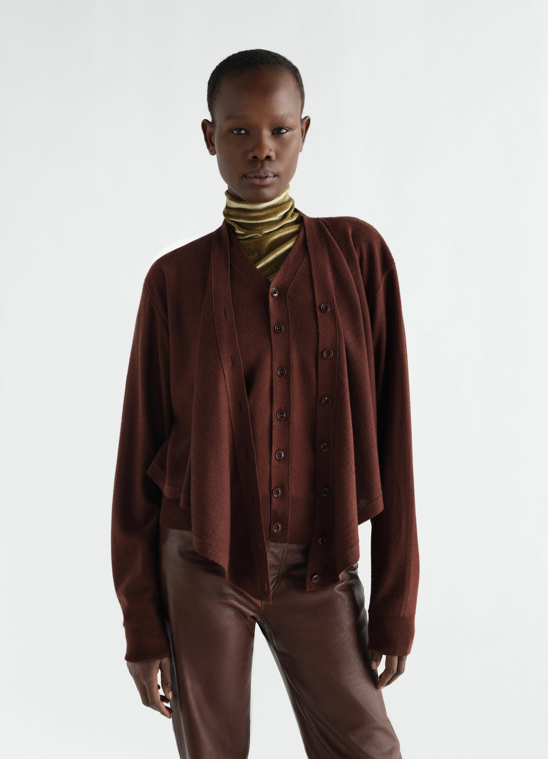 Trompe-L’Œil cardigan in brown merino wool blend worn by model with olive velvet turtleneck and leather pants LEMAIRE