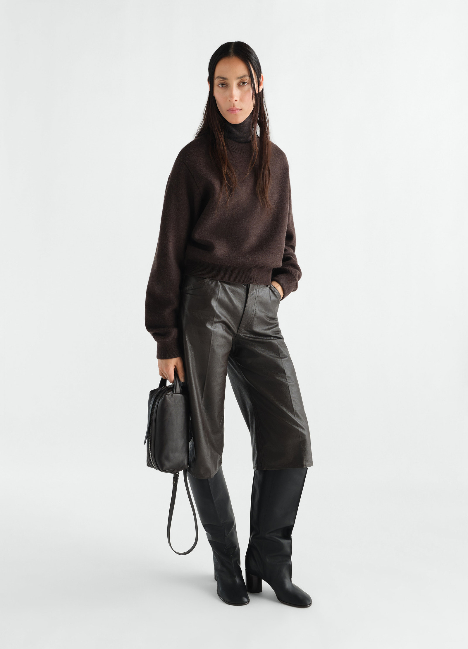Short brown felted merino wool sweater lemaire worn by a model with leather shorts and black boots