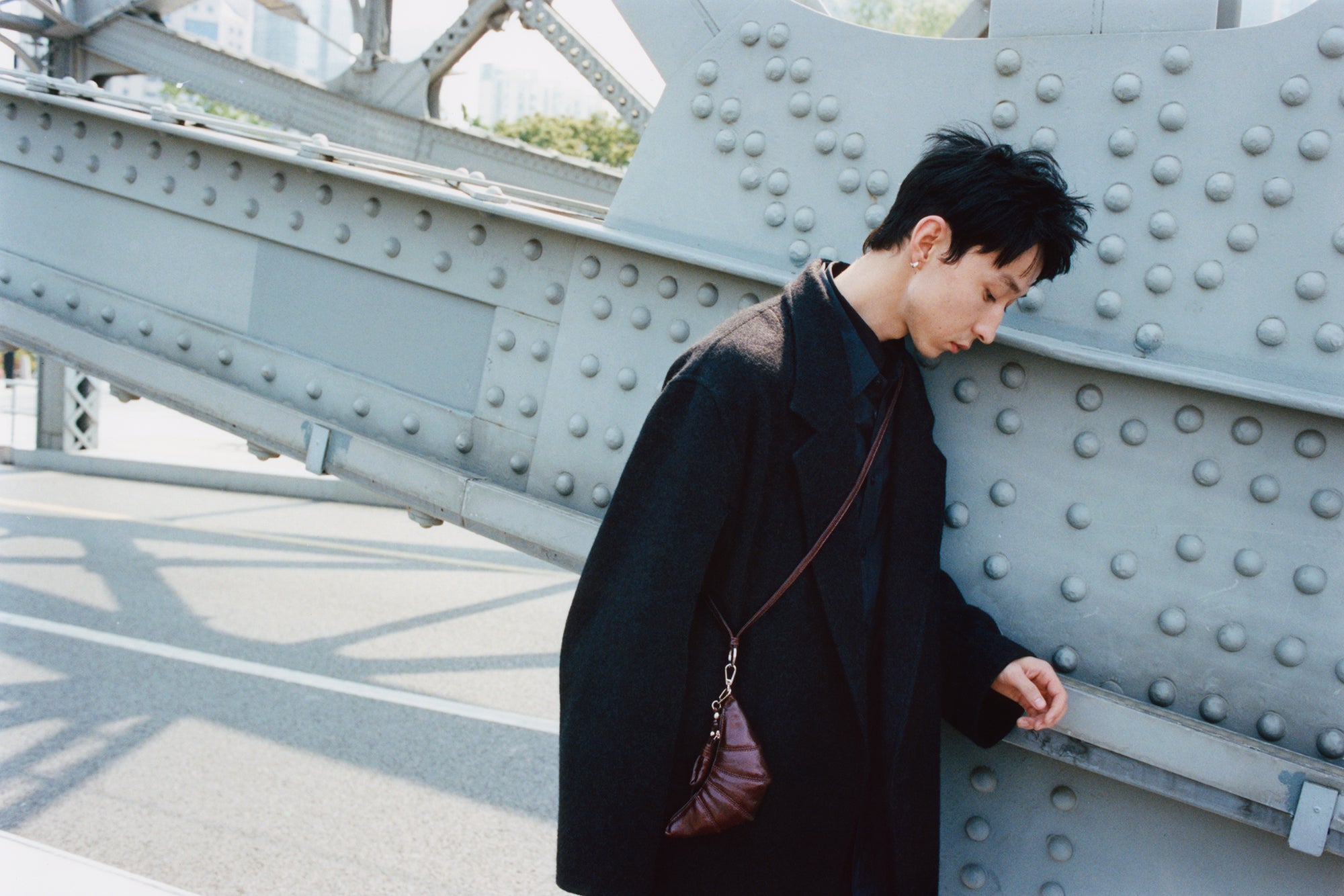 Black coat in Black wool, brown leather, model shot, Side view Oversized fit