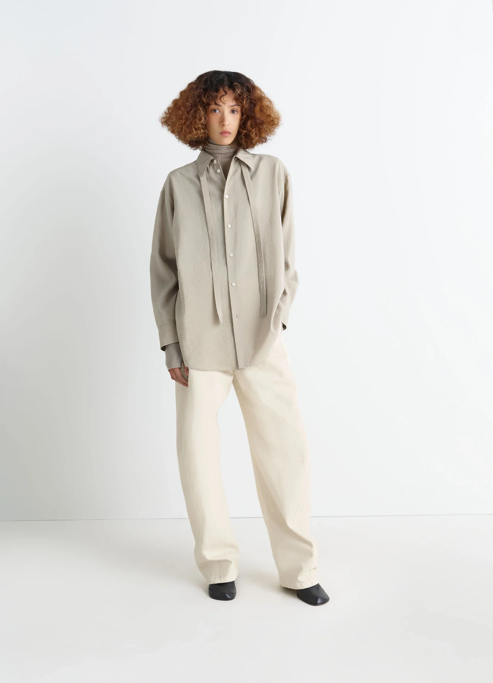 Lemaire long shirt with tie in dry silk blend, model shot, three-quarter view slightly crinkled texture
