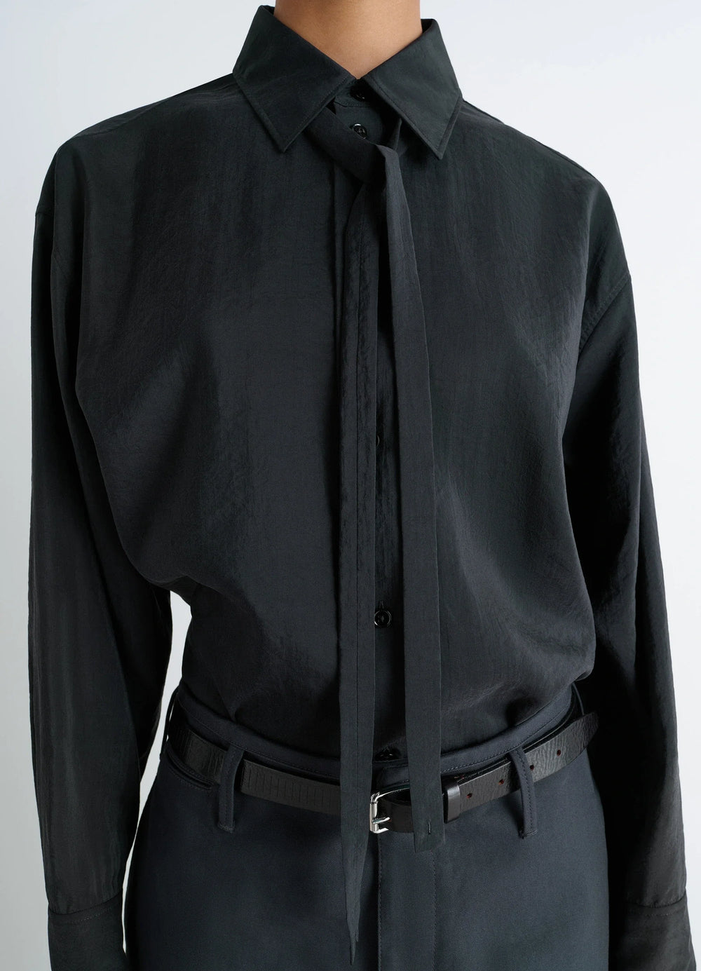 Lemaire Long Shirt with Tie in Black Dry Silk Blend, model shot, close-up torso view necktie-style unbuttoned