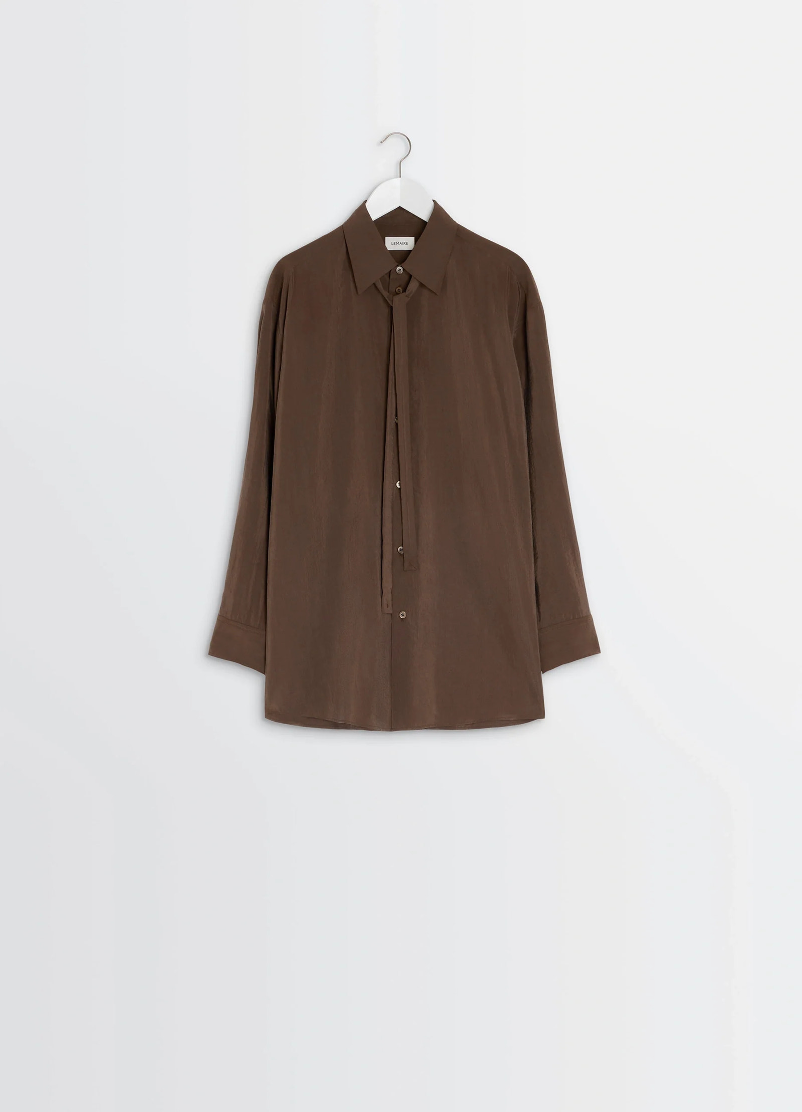 Lemaire long shirt with tie in dry silk blend, product shot, hanging view buttoned cuffs