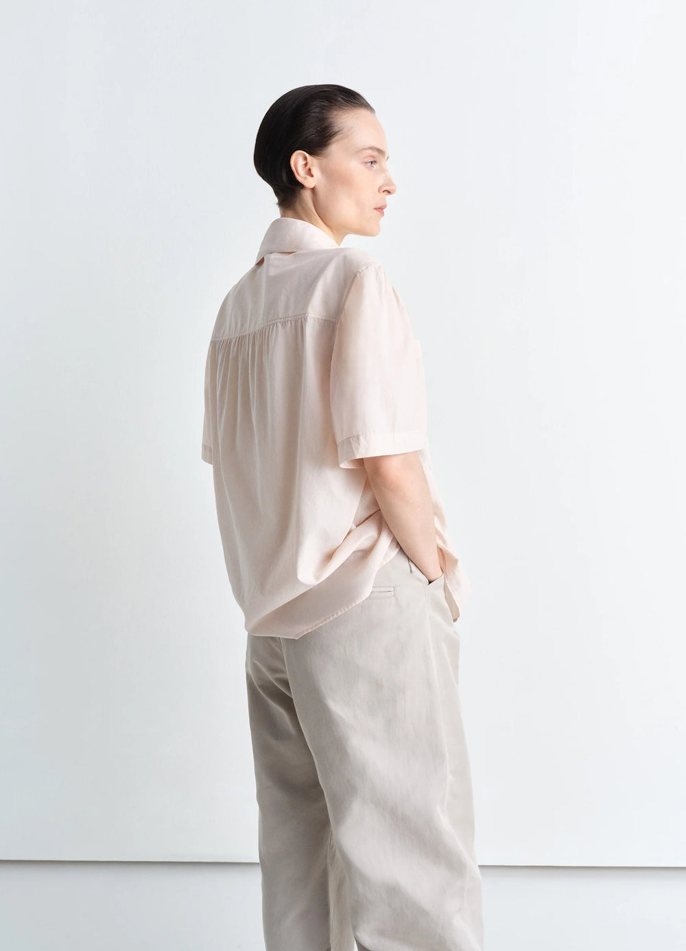 Lemaire Short Sleeve Shirt with Fou in Lightweight Washed Cotton Poplin, model shot, back view relaxed fit with yoke detail