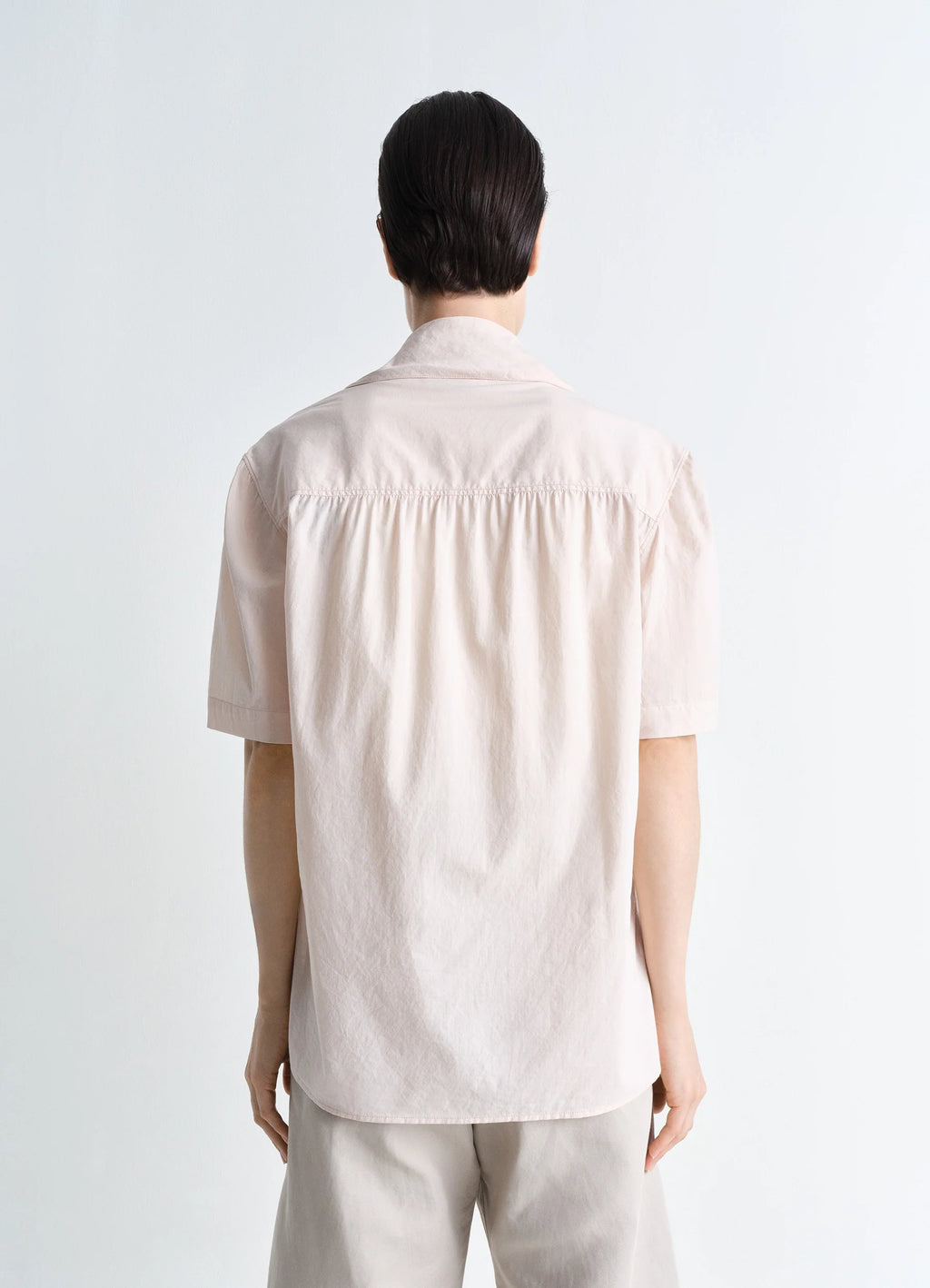 Lemaire Short Sleeve Shirt with Fou in Lightweight Washed Cotton Poplin, model shot, three-quarter back v gathered back yoke