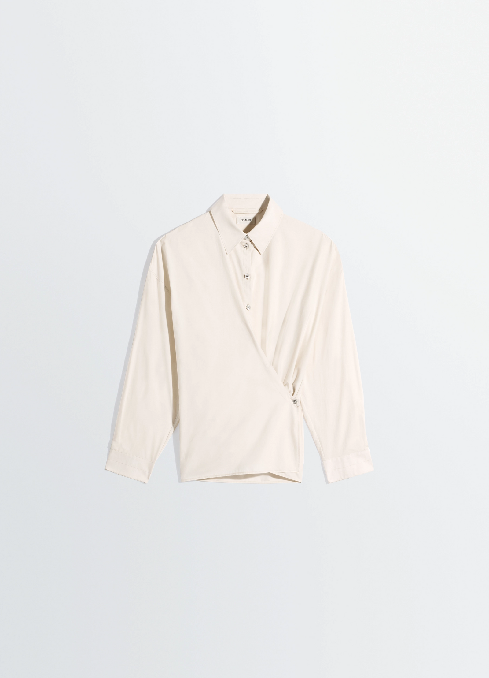 Straight collar twisted shirt in washed cotton silk, product shot, angled front view asymmetrical button row