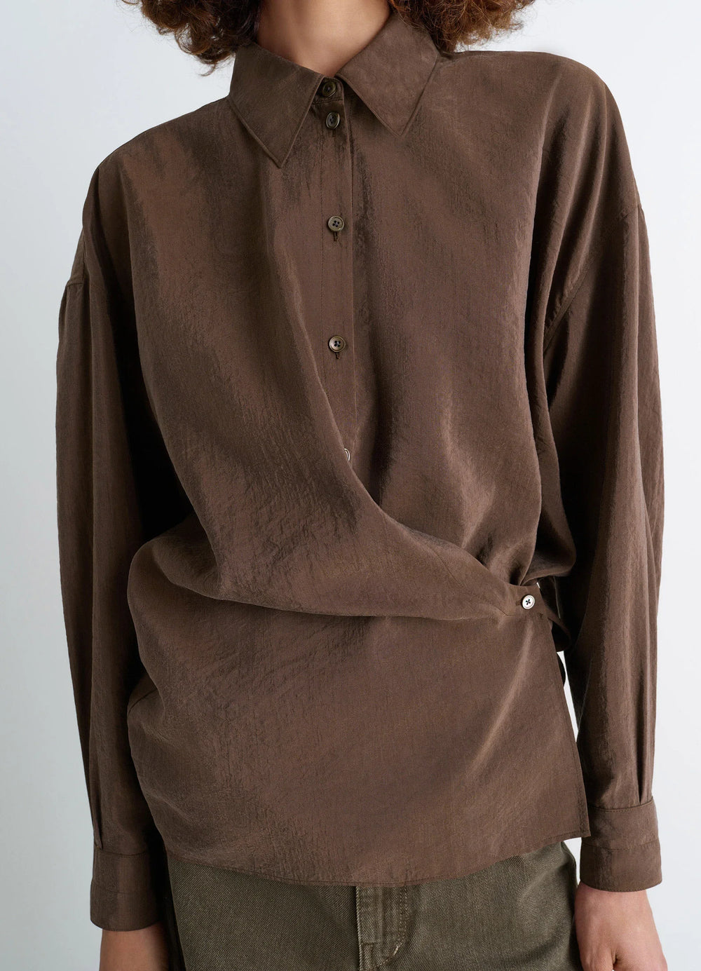 Lemaire Straight Collar Twisted Shi in Dry Silk Blend, model shot, close-up front view asymmetrical button detail