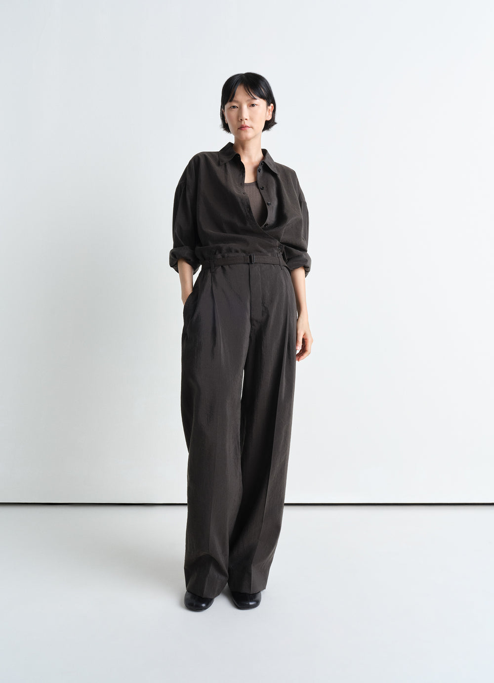 Lemaire Twisted Shirt in Dark Dry Silk, model shot, three-quarter view straight collar, rolled sleeves
