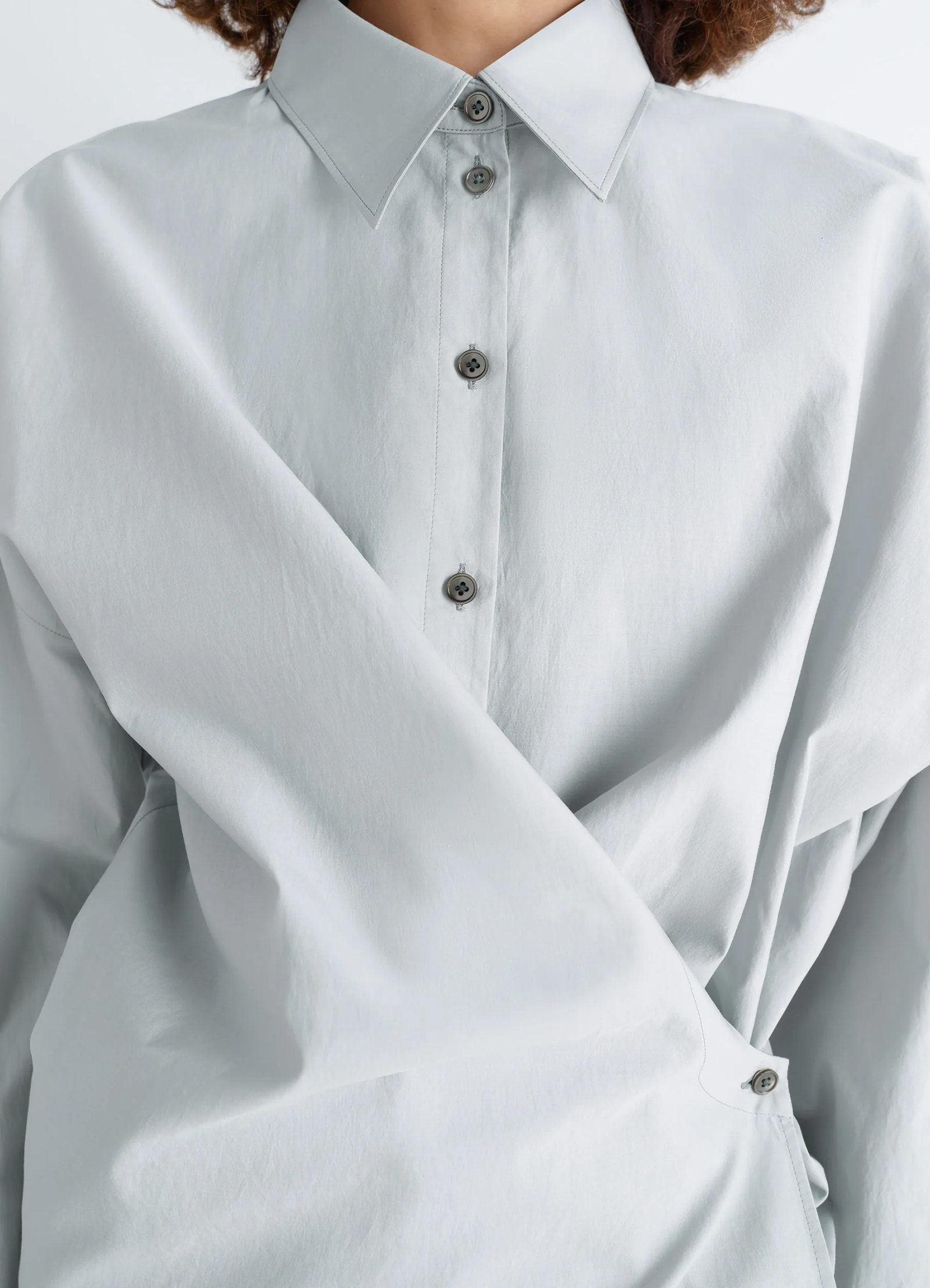 Lemaire twisted shirt in cotton-silk light patina, model shot, close-up front detail asymmetrical front wrap