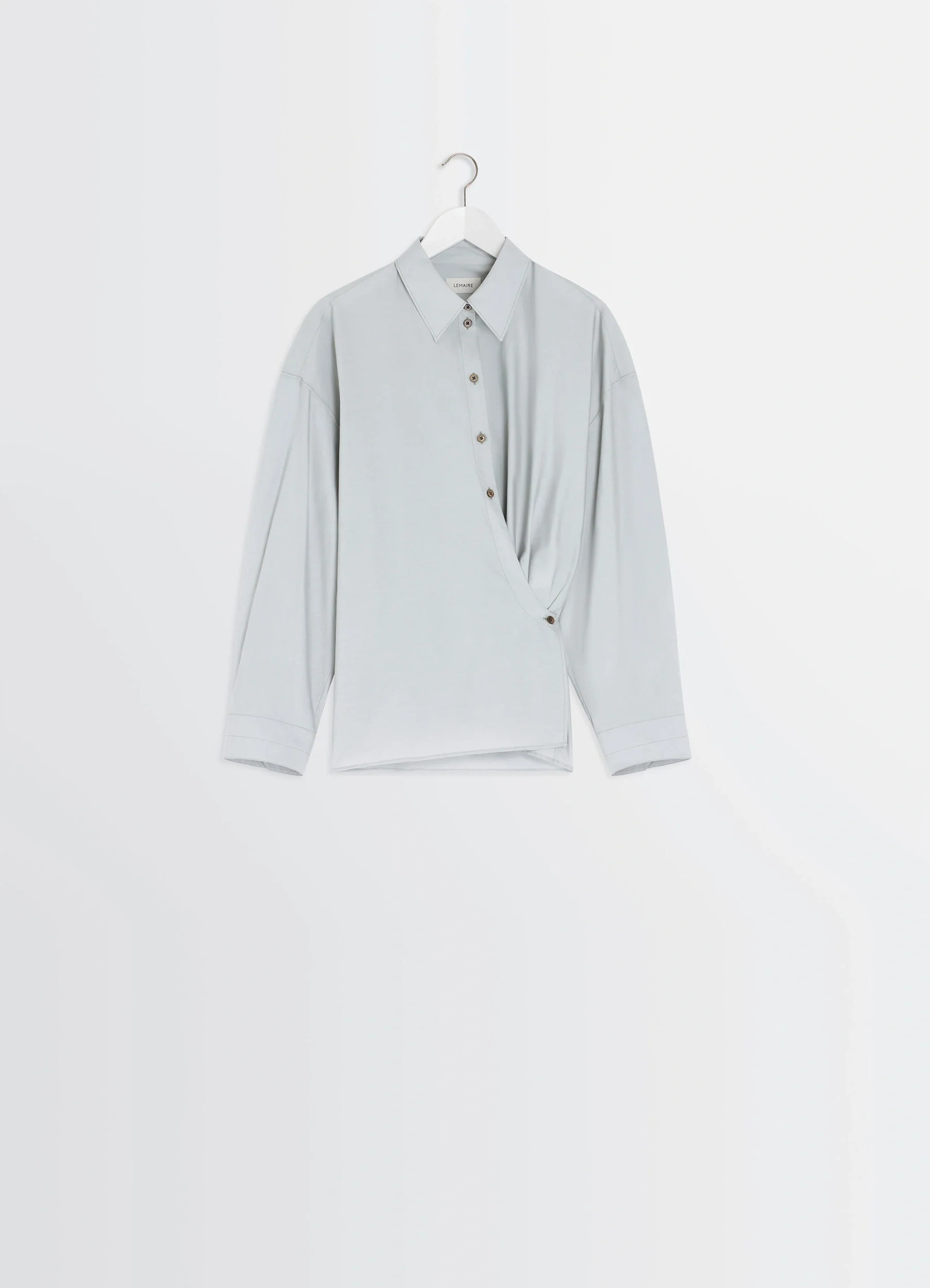 Lemaire twisted shirt in cotton-silk light patina, product shot, hanger display view asymmetrical hem design