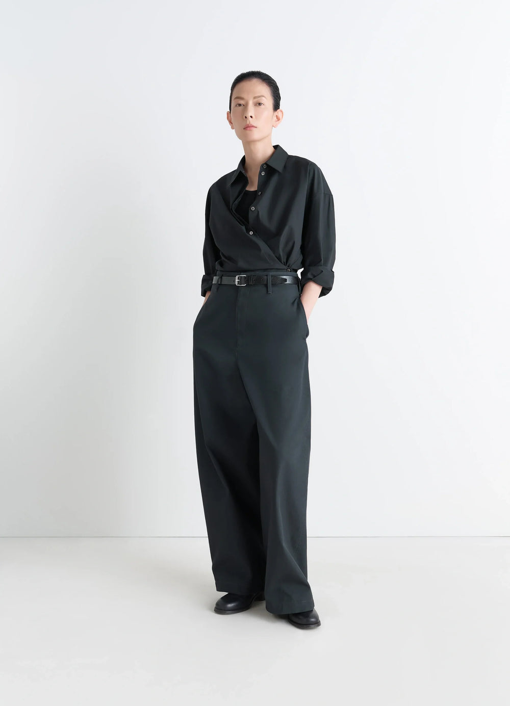 Lemaire Straight Collar Twisted Shi in Black washed cotton-silk blend, model shot, three-quarter view relaxed fit with tucked