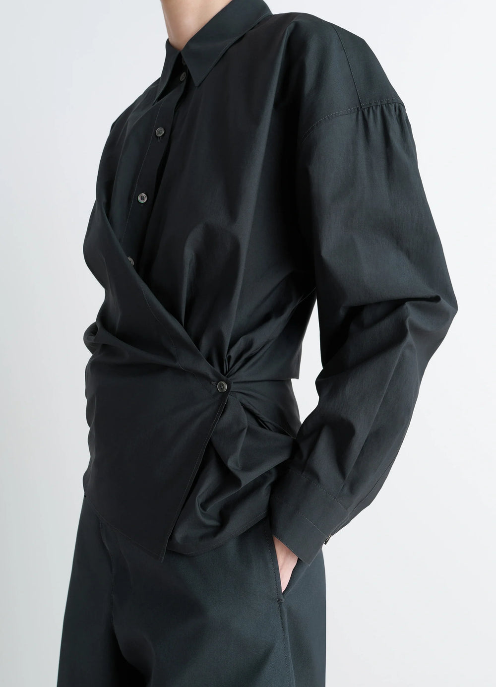 Lemaire Straight Collar Twisted Shi in Black washed cotton-silk blend, model shot, side view asymmetrical button detail