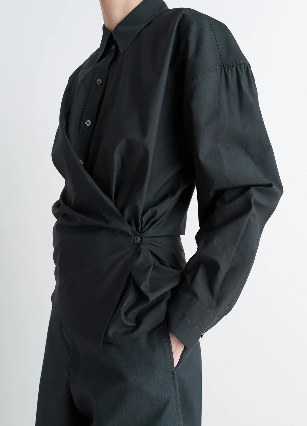 Lemaire Straight Collar Twisted Shi in Black washed cotton-silk blend, model shot, side view asymmetrical button detail