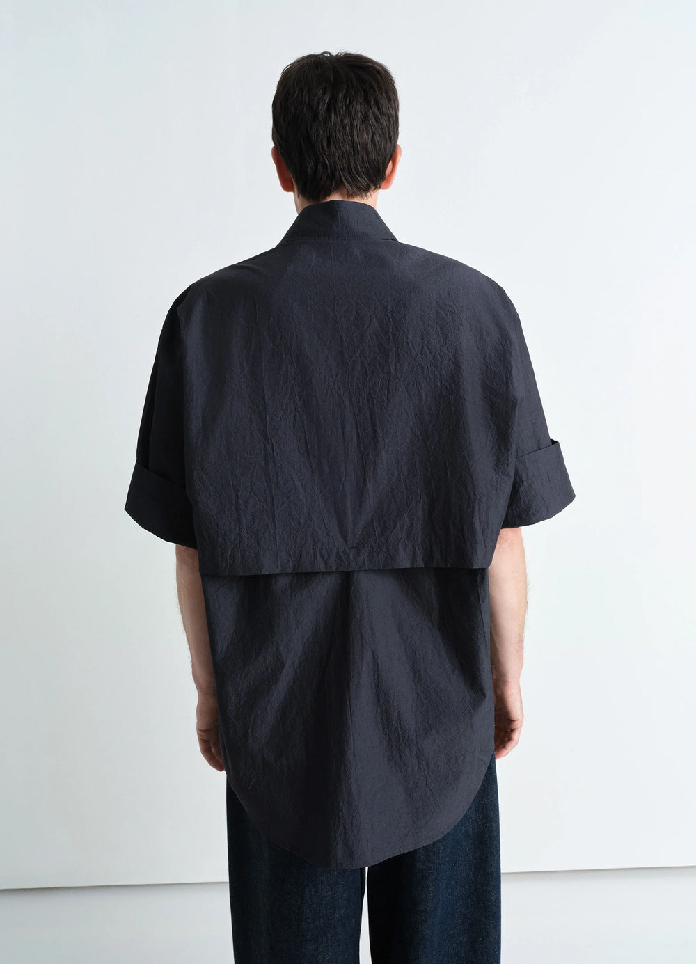 Utility Shirt in Dark Cotton Crepe, model shot, back view dropped back hem