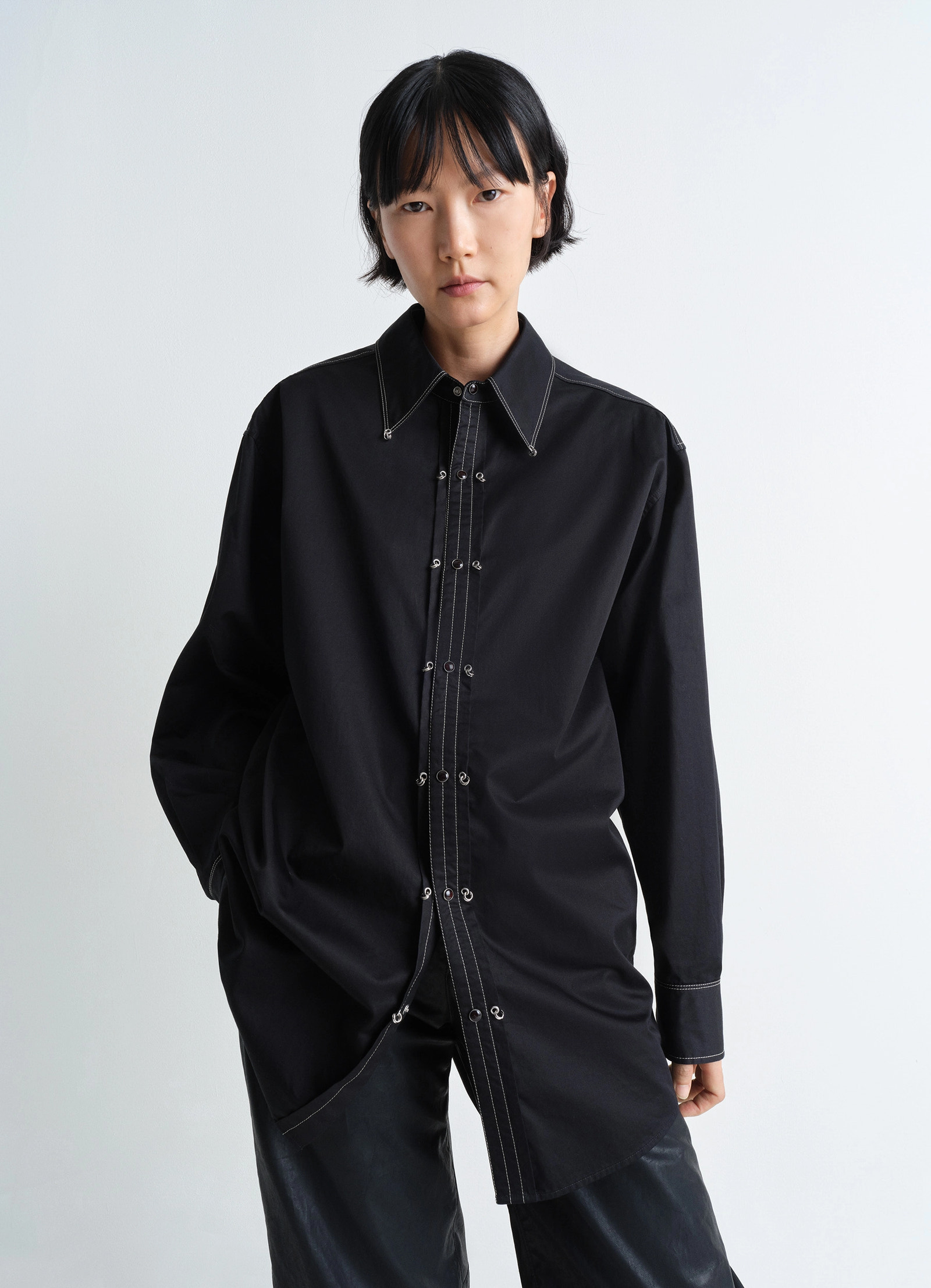 Embellished metal shirt in black cotton satin, model shot, three-quarter view oversized fit visible