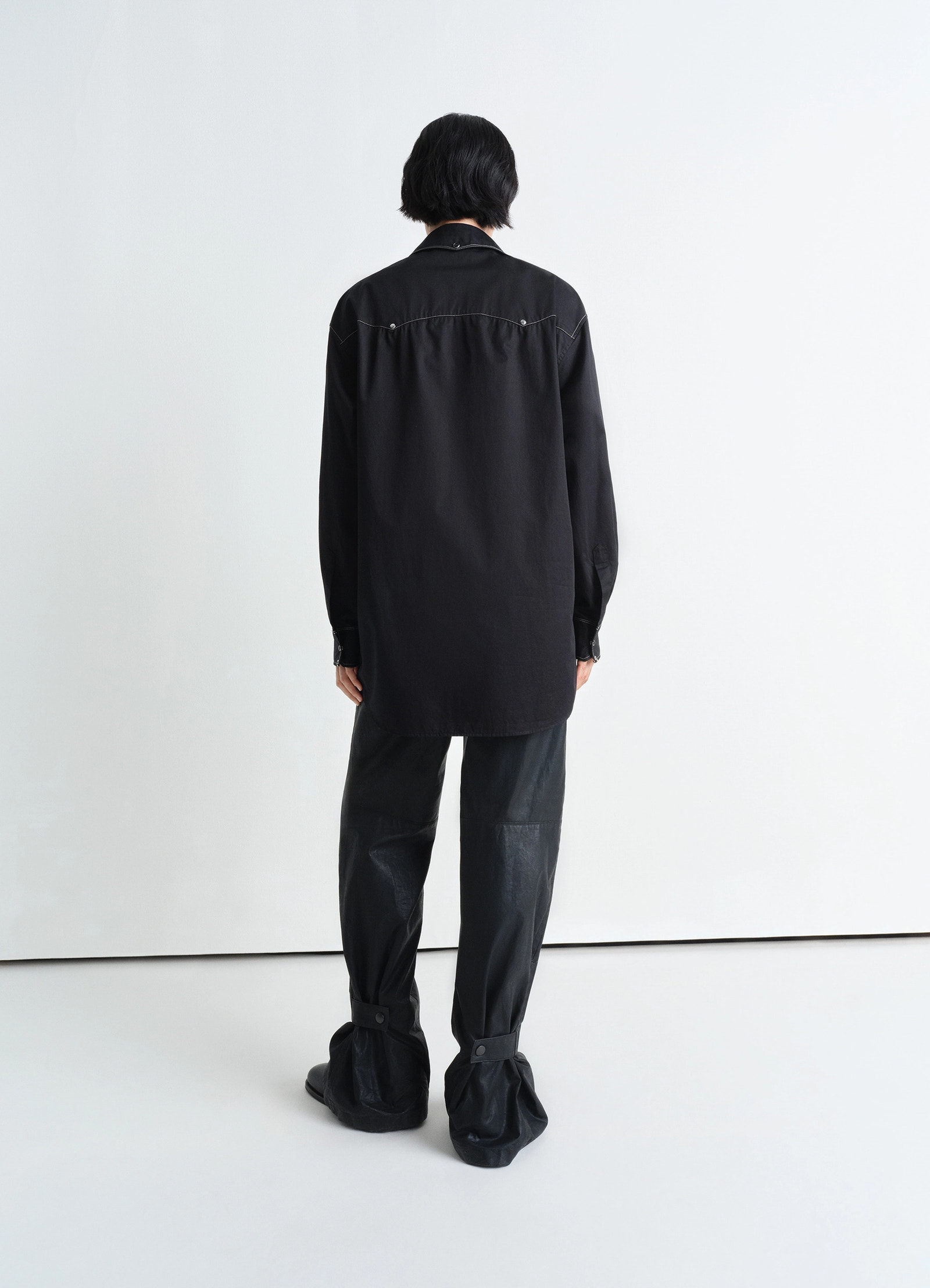 Embellished metal shirt in black cotton satin, model shot, back three-quarter view drop shoulder design visible
