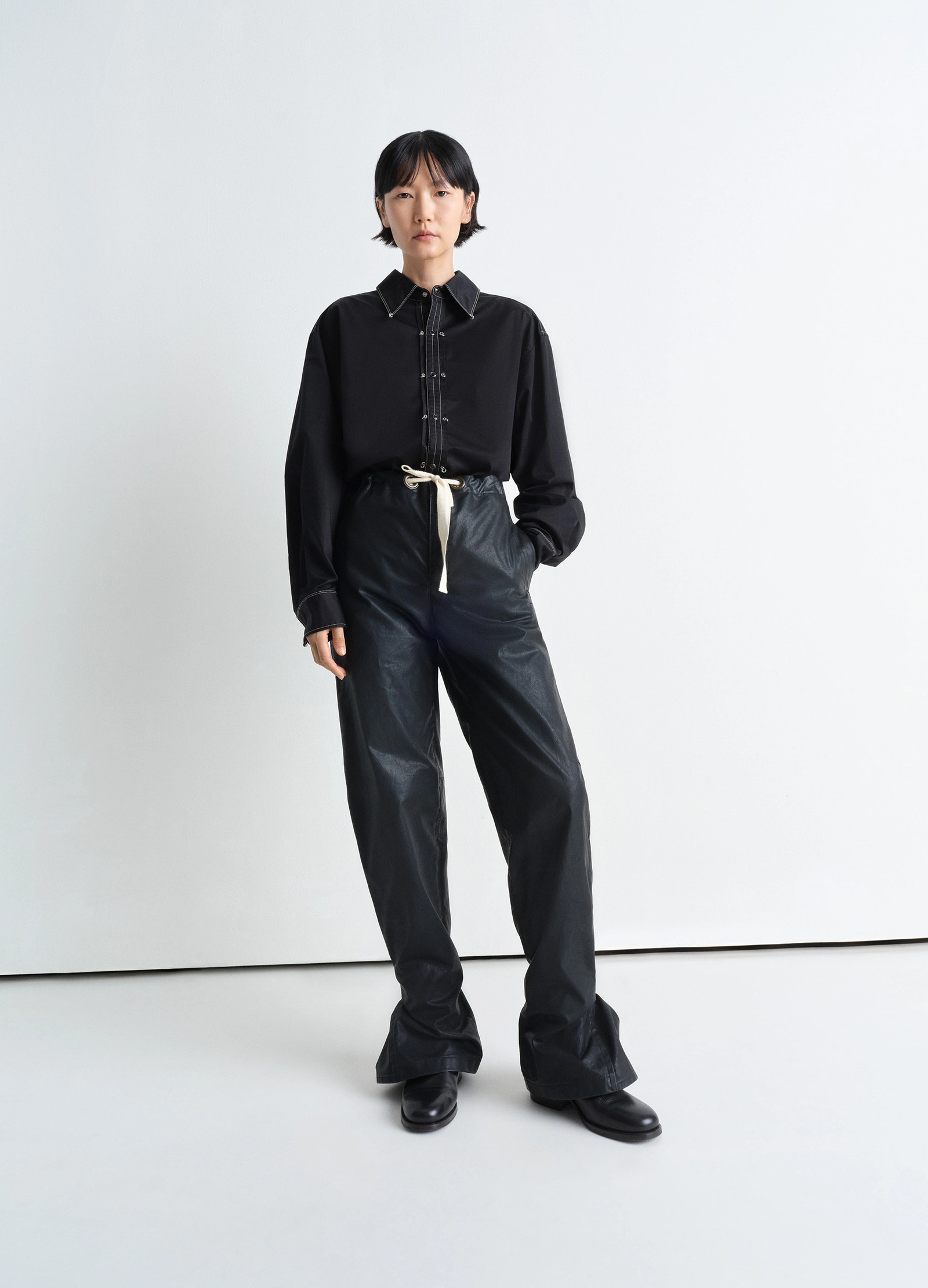 Embellished metal shirt in black cotton satin, model shot, full body front view styled with high waist pants