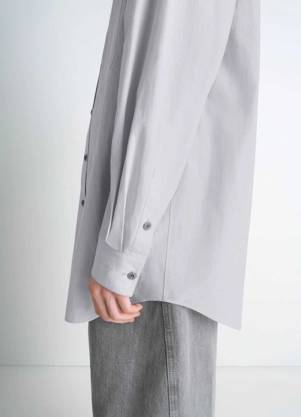 Lemaire Double Pocket Shirt in Light Gray Cotton Crepe, model shot, side detail buttoned cuffs