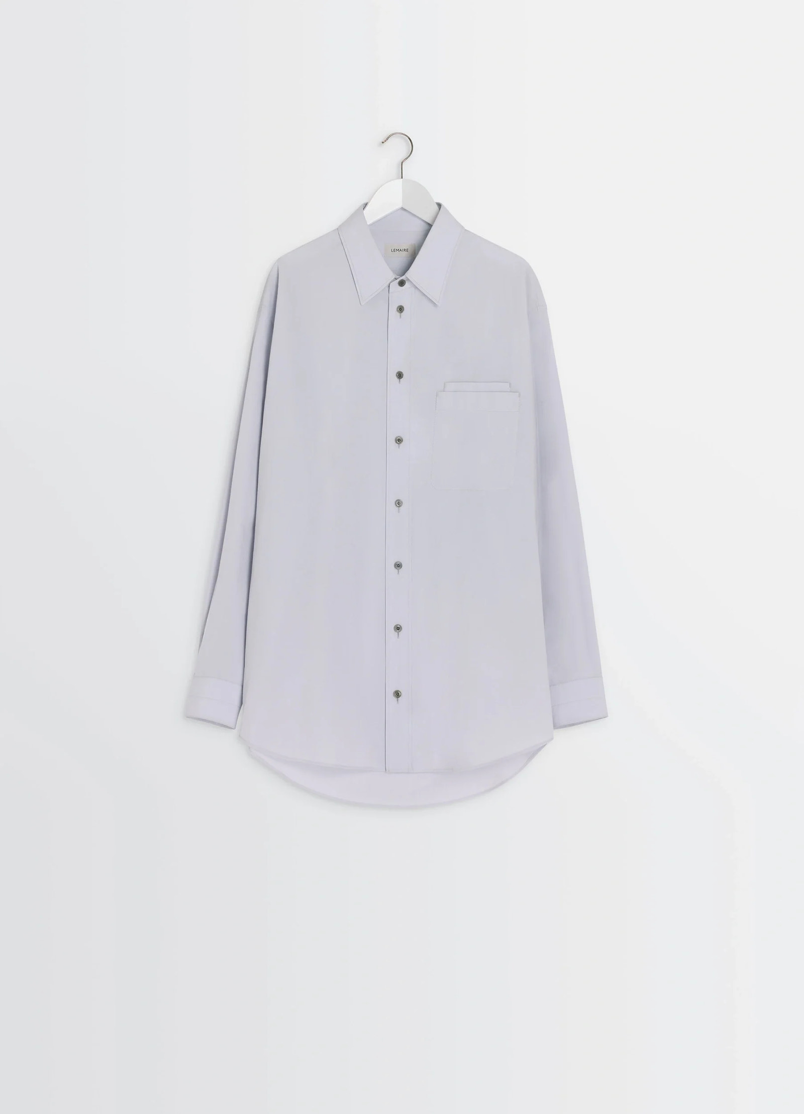Lemaire double pocket shirt in light gray cotton crepe, product shot, hung front on hanger tailored hem