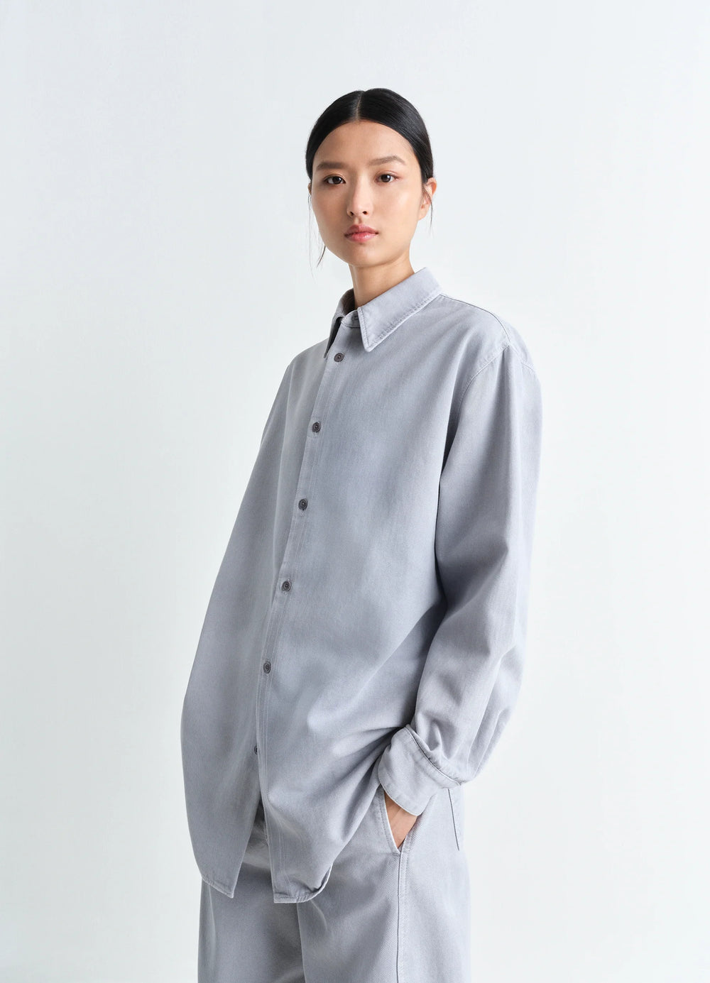Lemaire Relaxed Shirt in Garment Dyed Snow Denim, model shot, Three-quarter view Relaxed fit, dropped shoulder