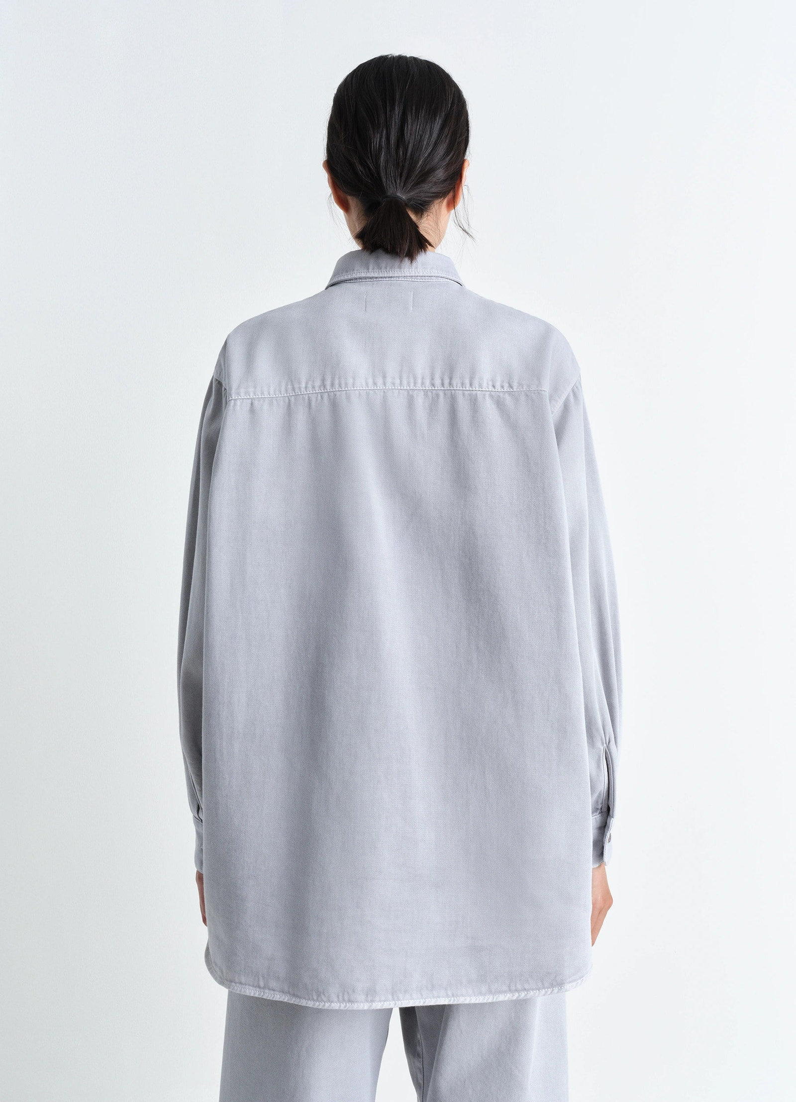 Lemaire relaxed shirt in garment dyed snow denim, model shot, back view long hemline