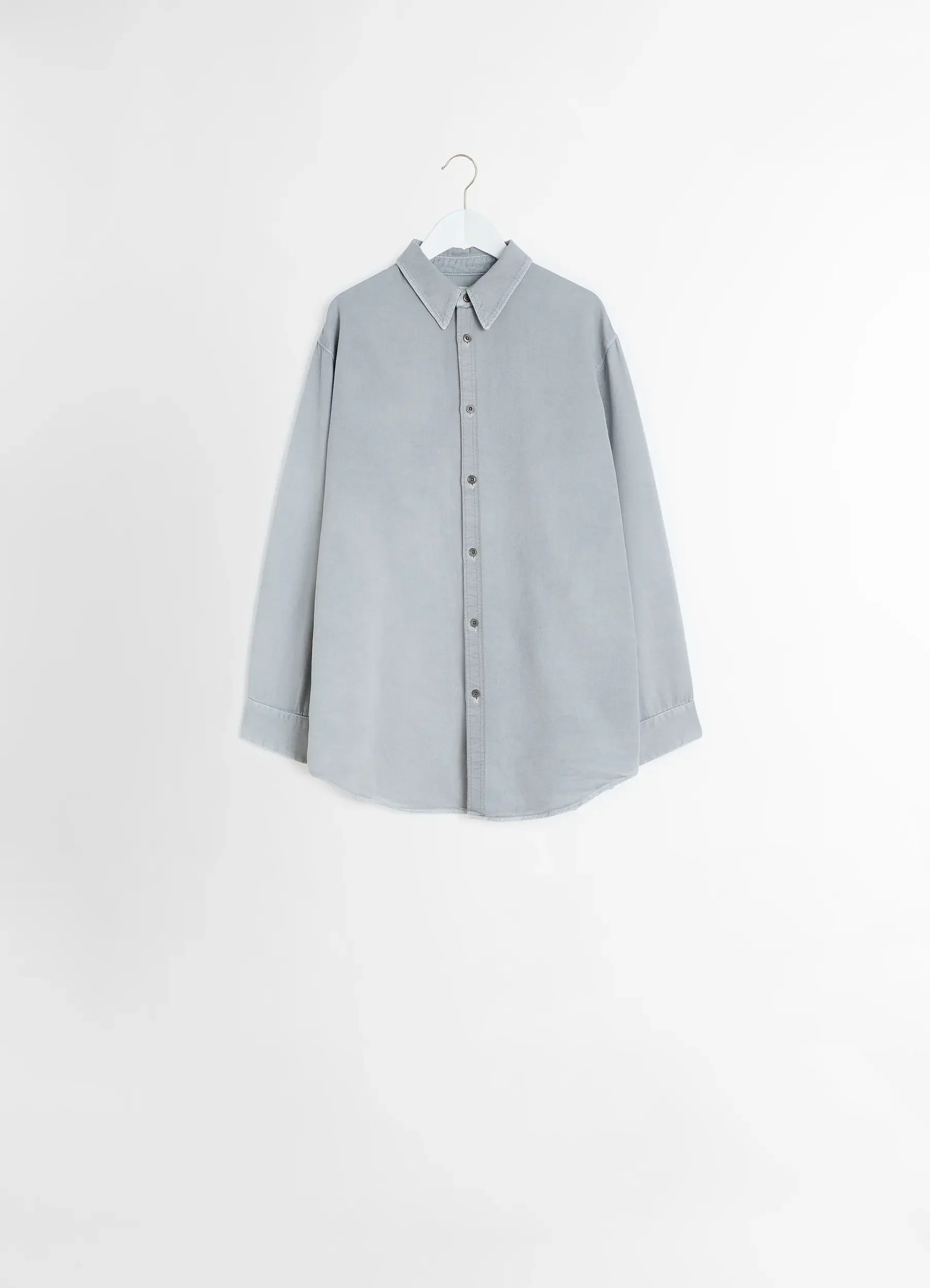Lemaire relaxed shirt in garment dyed snow denim, product shot, straight hanging view rounded hem, single cuff