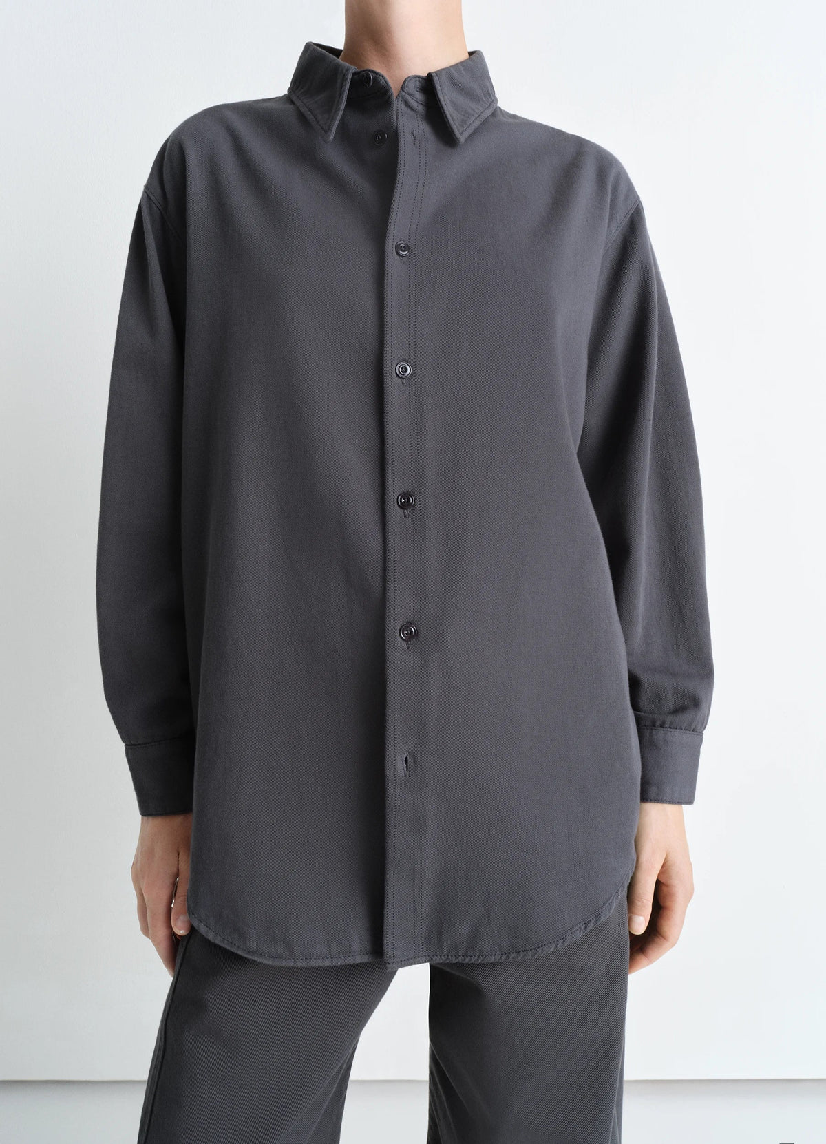 Lemaire Relaxed Shirt in deep carbon blue light denim, model shot, front view dropped shoulder relaxed fit