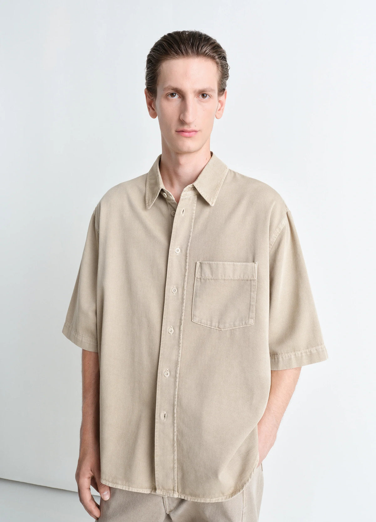 Lemaire Short Sleeve Denim Shirt in Garment Dyed Snow Light Denim, model shot, Front view Oversized relaxed fit