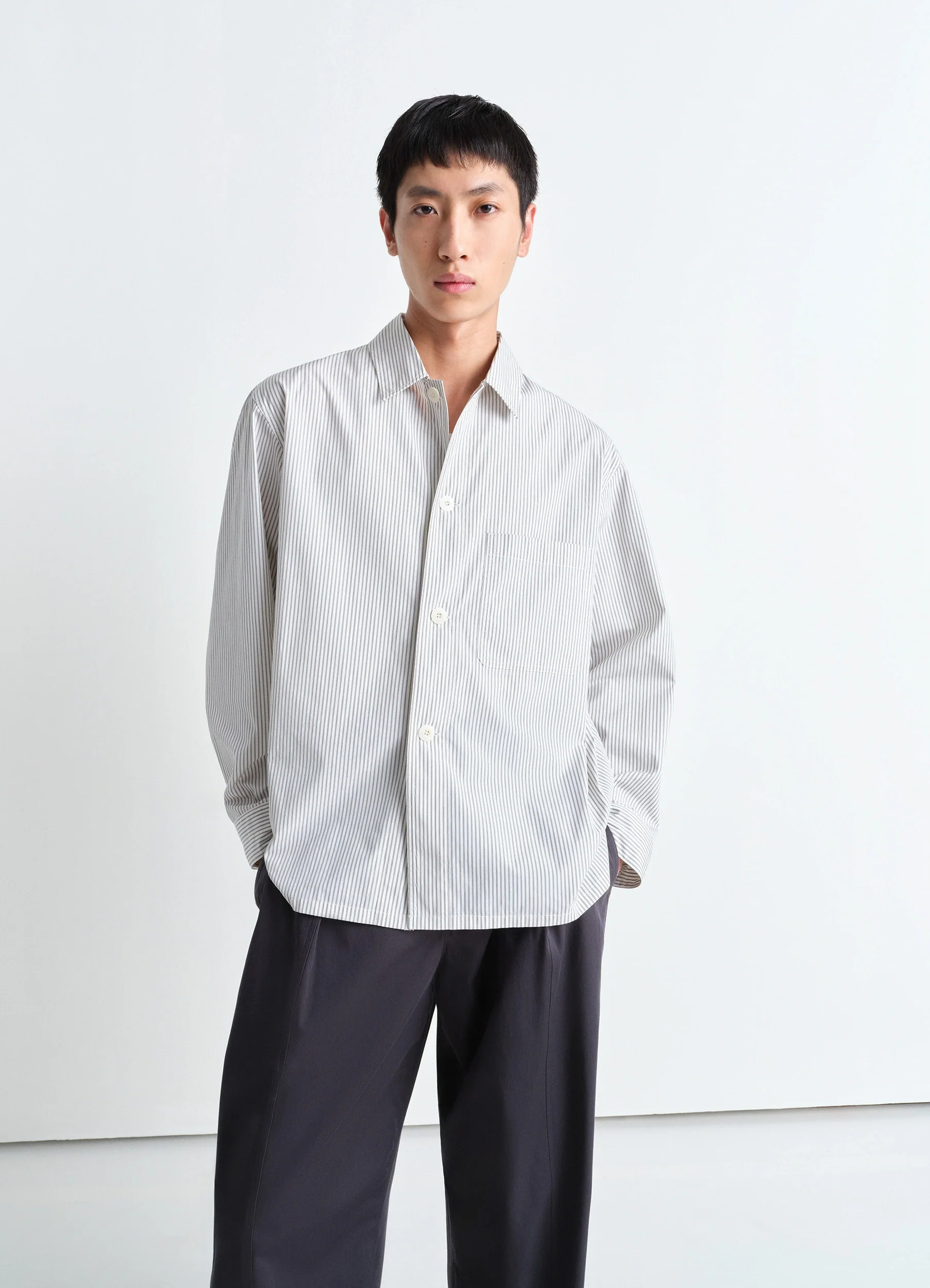 Lemaire pyjama shirt in striped cotton poplin, model shot, three-quarter view relaxed fit, button cuffs