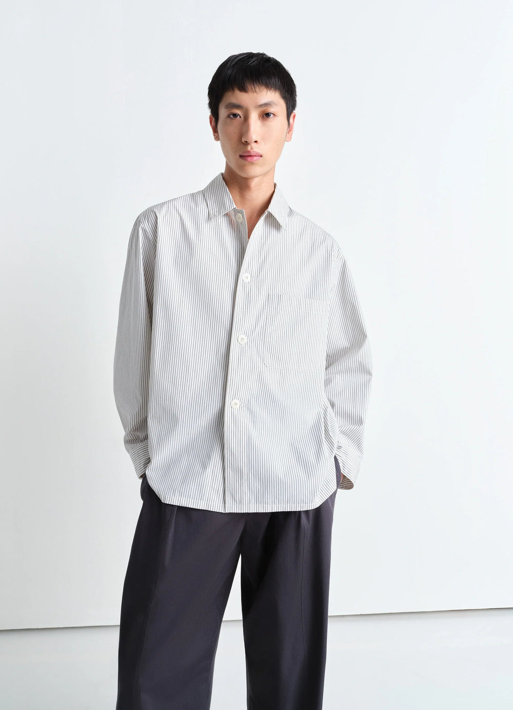 Lemaire Pyjama Shirt in Striped Cotton Poplin, model shot, three-quarter view relaxed fit, button cuffs
