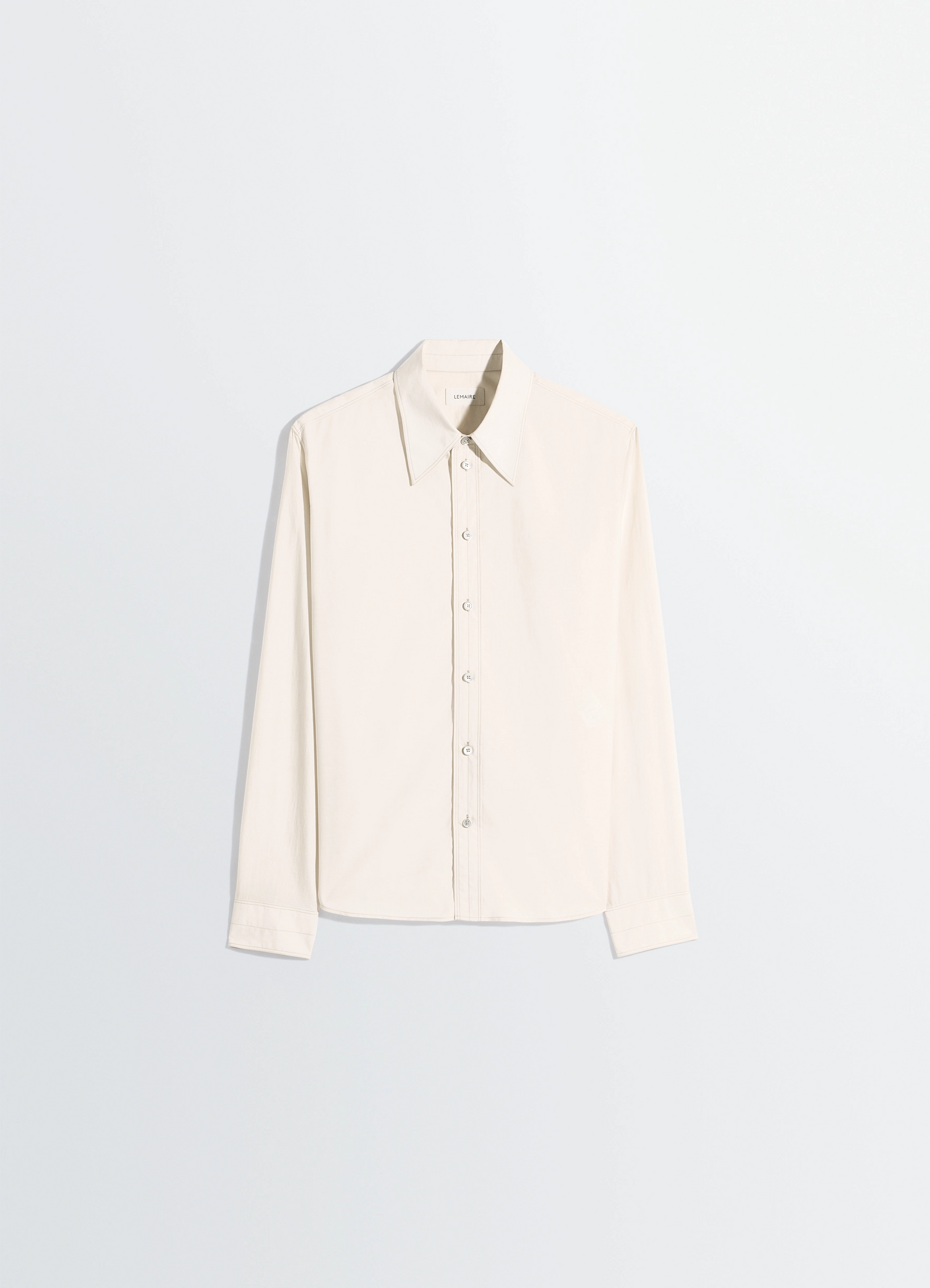 Pointed collar shirt in washed cotton silk, product shot, angled top view straight sleeve hang