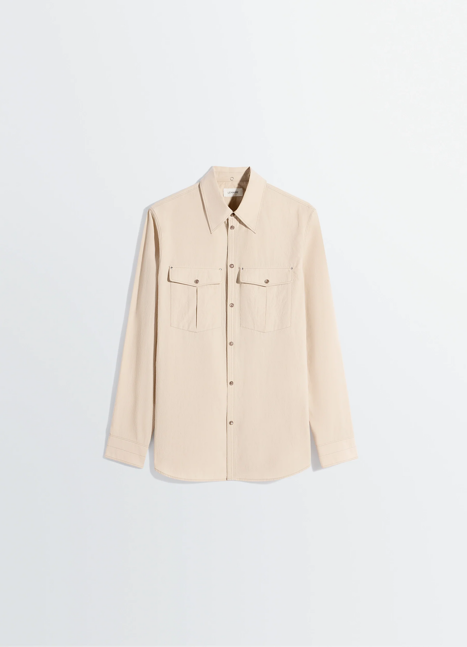 Lemaire chest-pocket fitted shirt in crepe cotton in beige, product shot, side angled view buttoned chest pockets