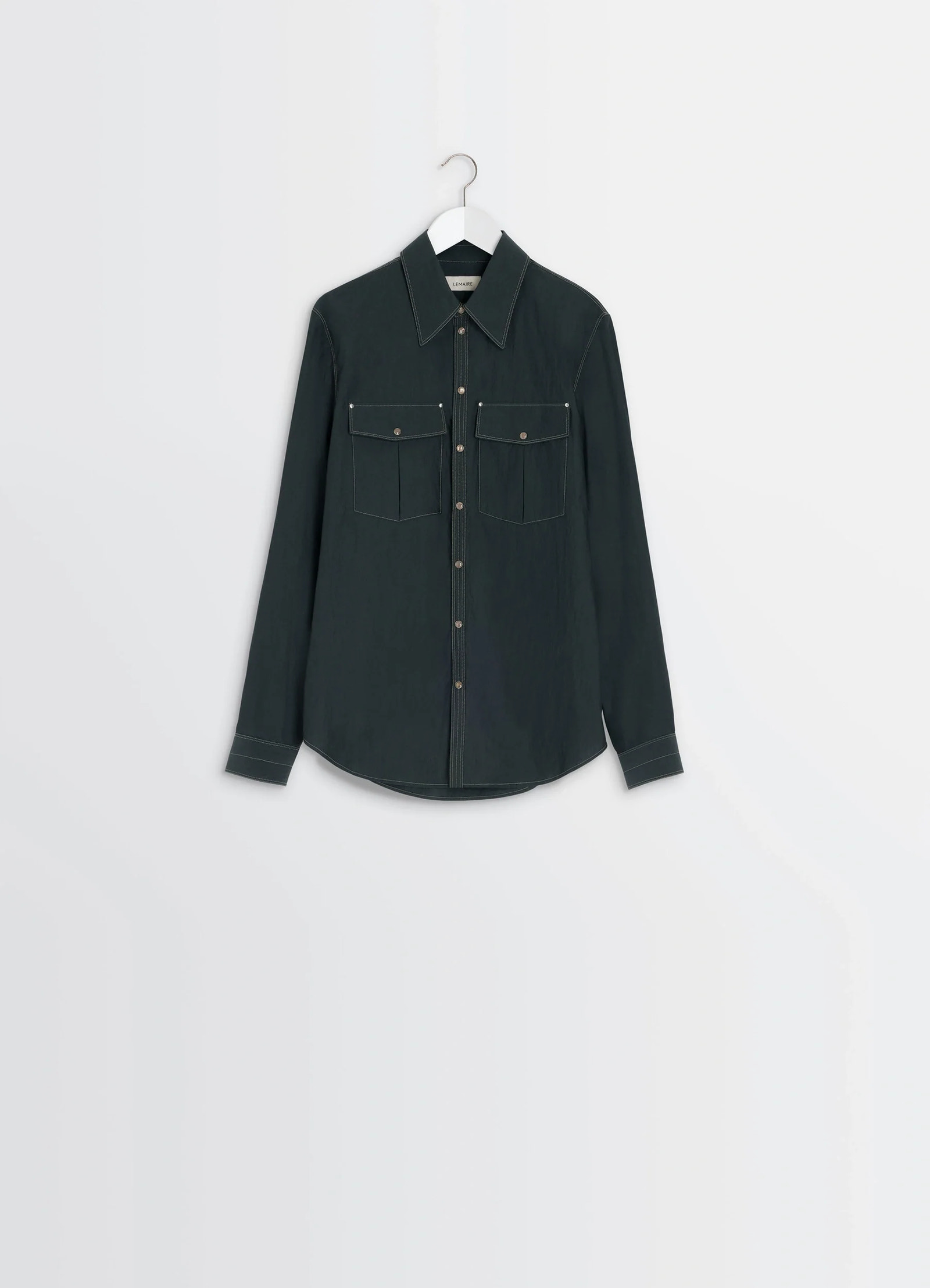 Chest-pocket fitted shirt in dark cotton crepe, product shot, angled shoulder view contrasting stitching detail