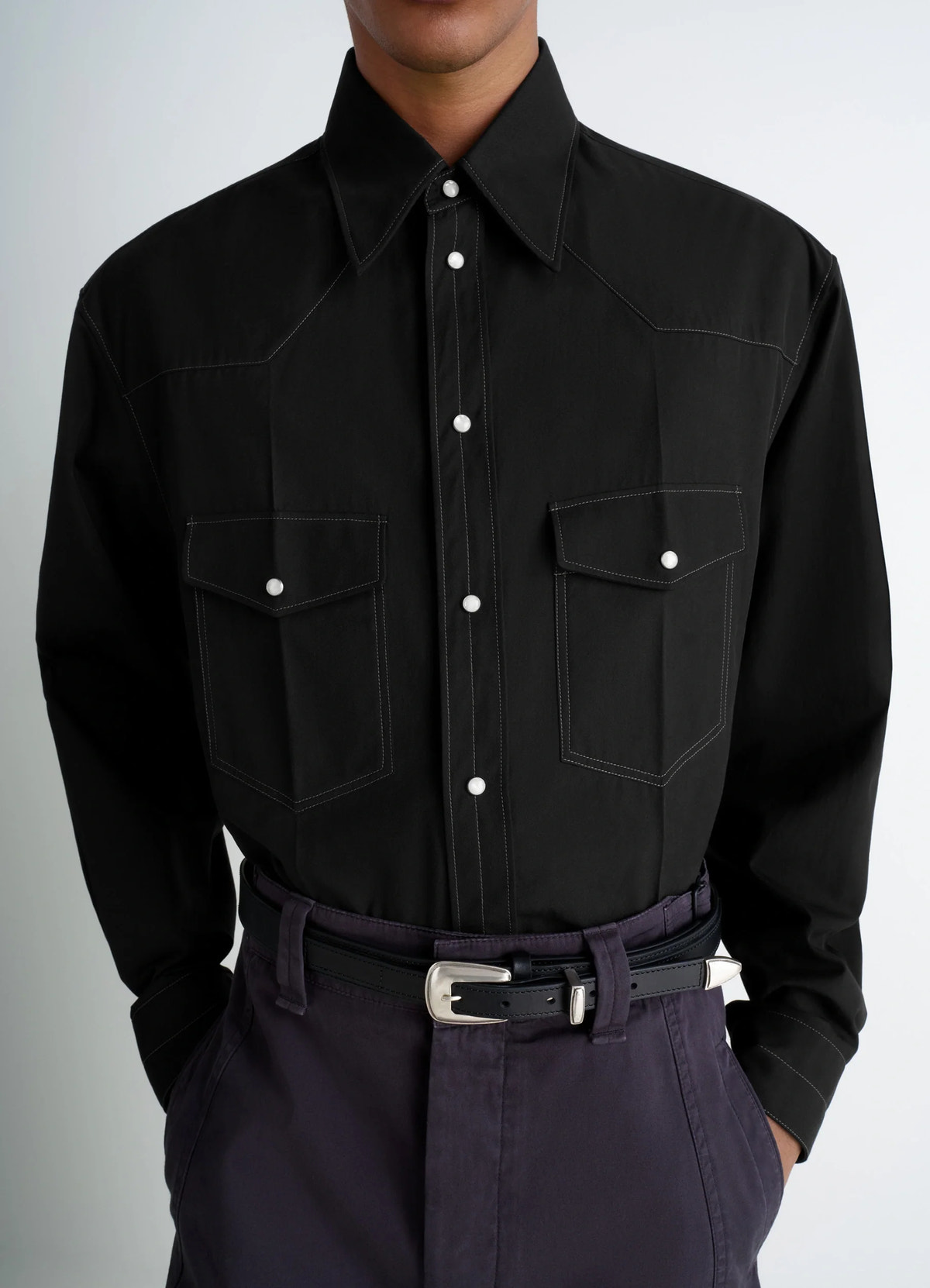 Western shirt in black cotton twill, model shot, mid-torso view stitch details, tuck-in style