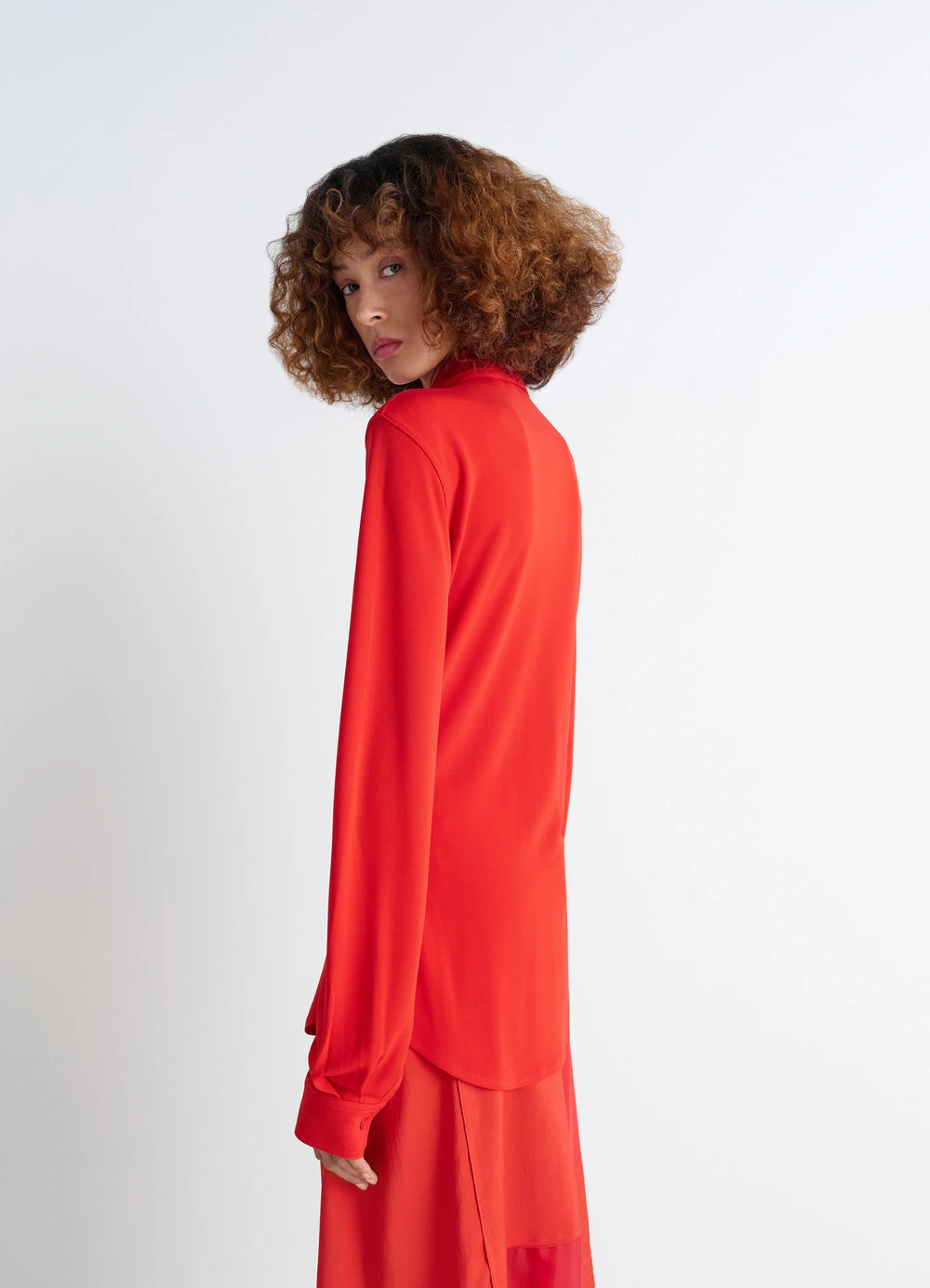 Lemaire Soft Fitted Shirt in Red Viscose Crepe Jersey, model shot, back view curved hem detail