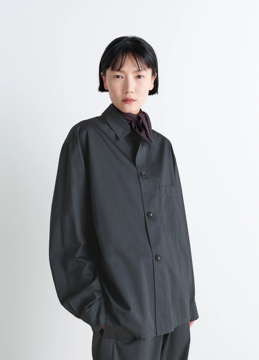 Lemaire Pyjama Shirt in Black Satin Finish Cotton, model shot, close-up view single chest pocket
