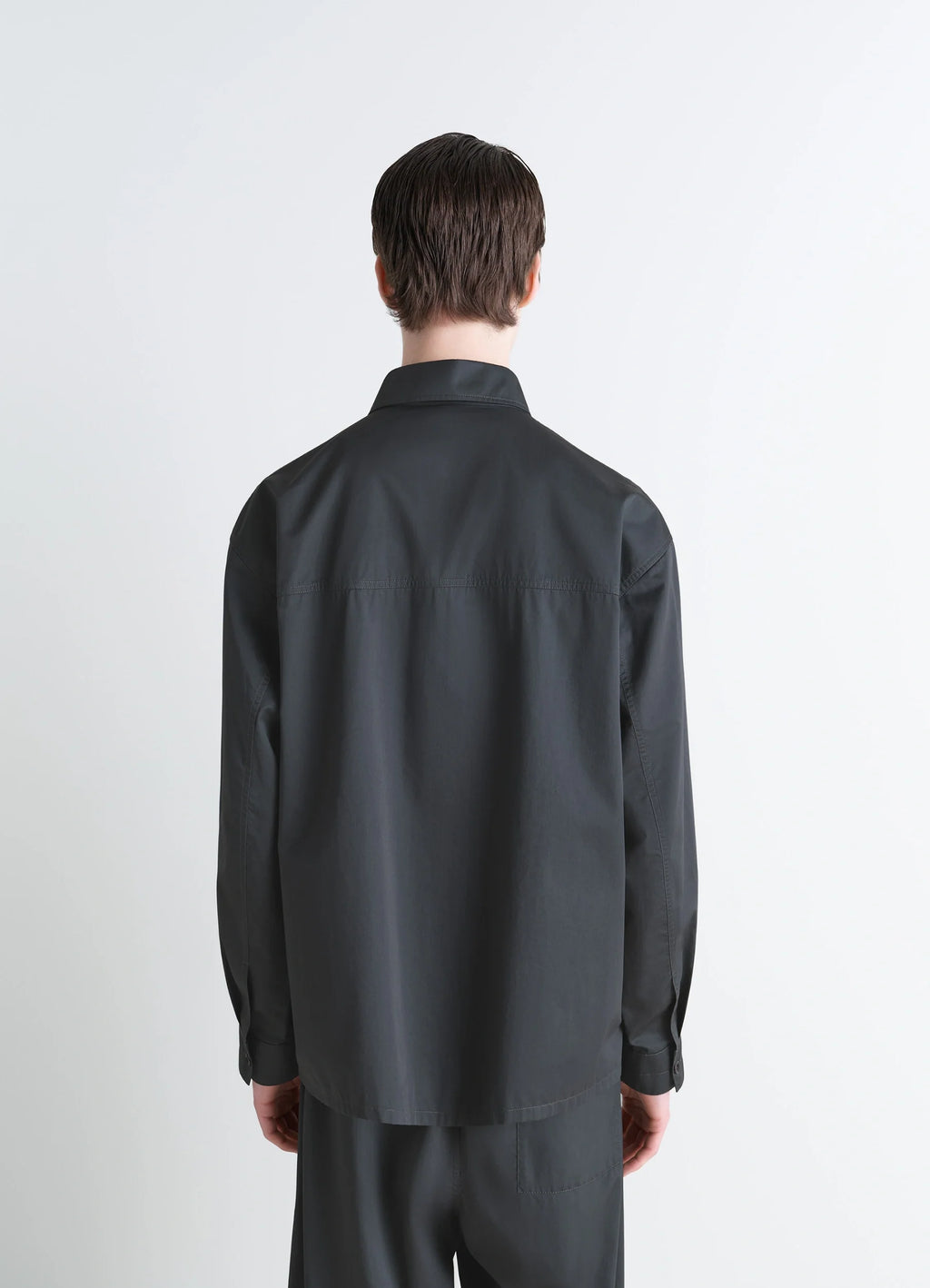 Lemaire Pyjama Shirt in Black Satin Finish Cotton, model shot, back view straight hemline