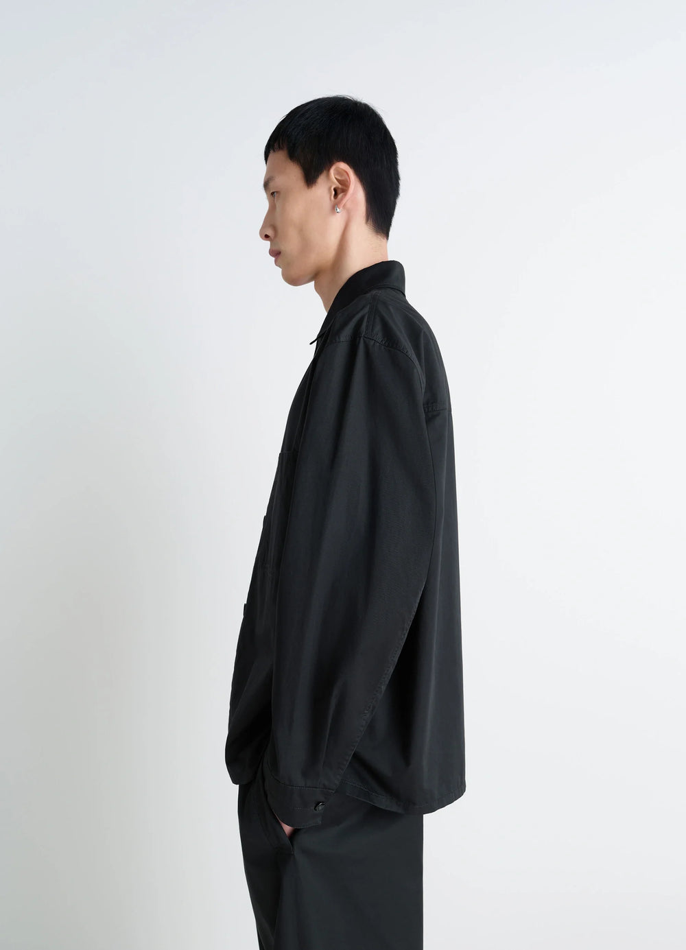 Lemaire Pyjama Shirt in Black Lightweight Cotton, model shot, side profile view loose sleeves, single cuff
