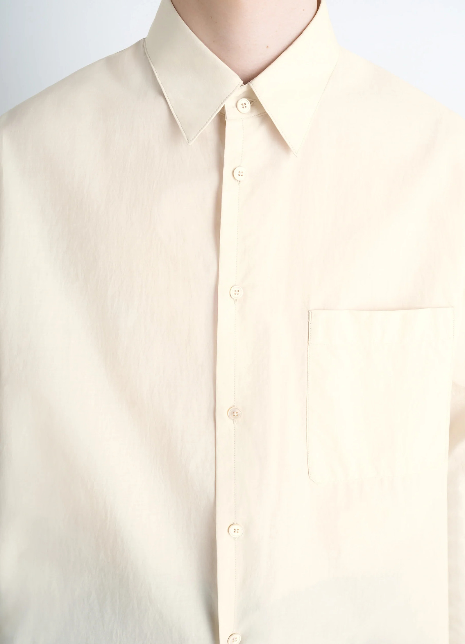 Lemaire regular shirt in washed cotton and silk, model shot, close-up front chest pocket detail