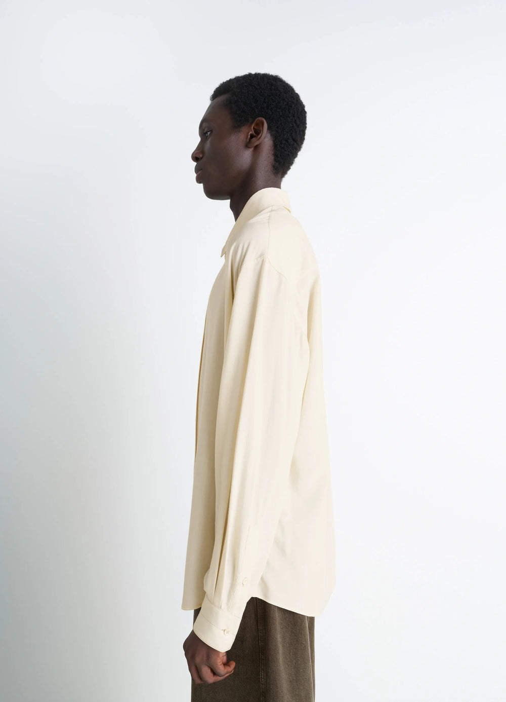Lemaire Relaxed Shirt in Light Viscose Wool Blend, model shot, side profile view smooth sleeve drape