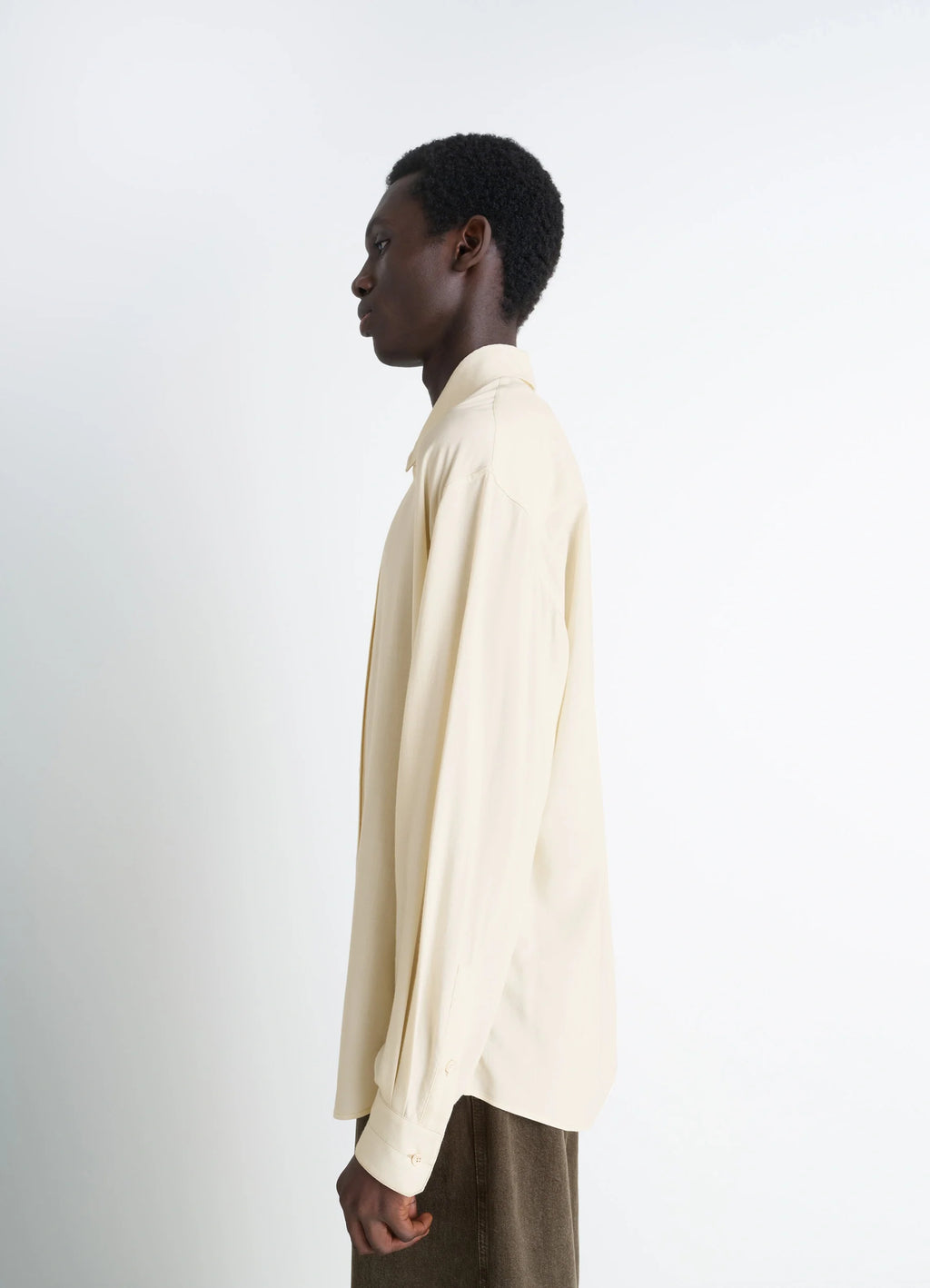Lemaire Relaxed Shirt in Light Viscose Wool Blend, model shot, side profile view smooth sleeve drape