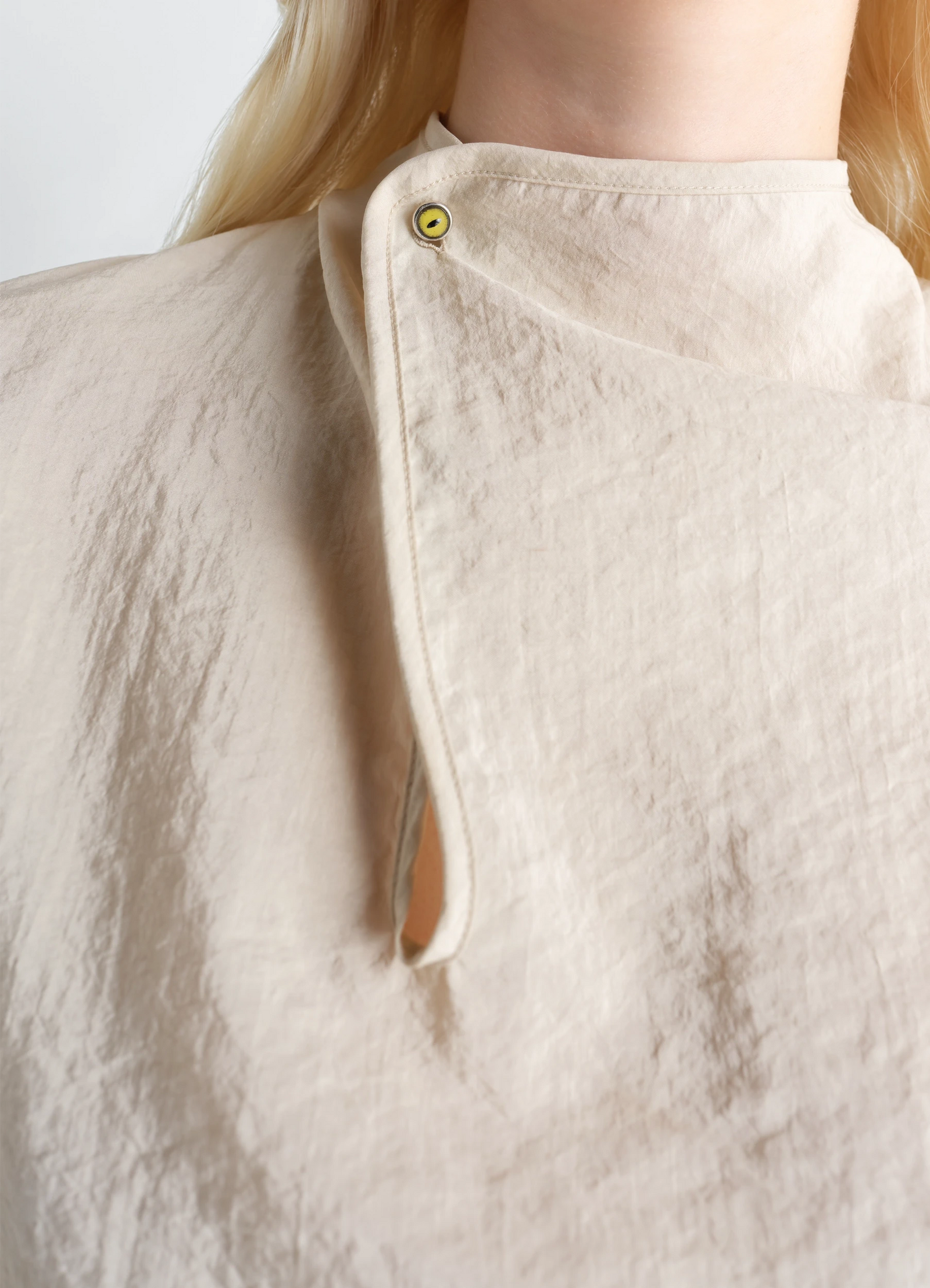 Soft collar top in dry silk, model shot, close-up detail asymmetrical button